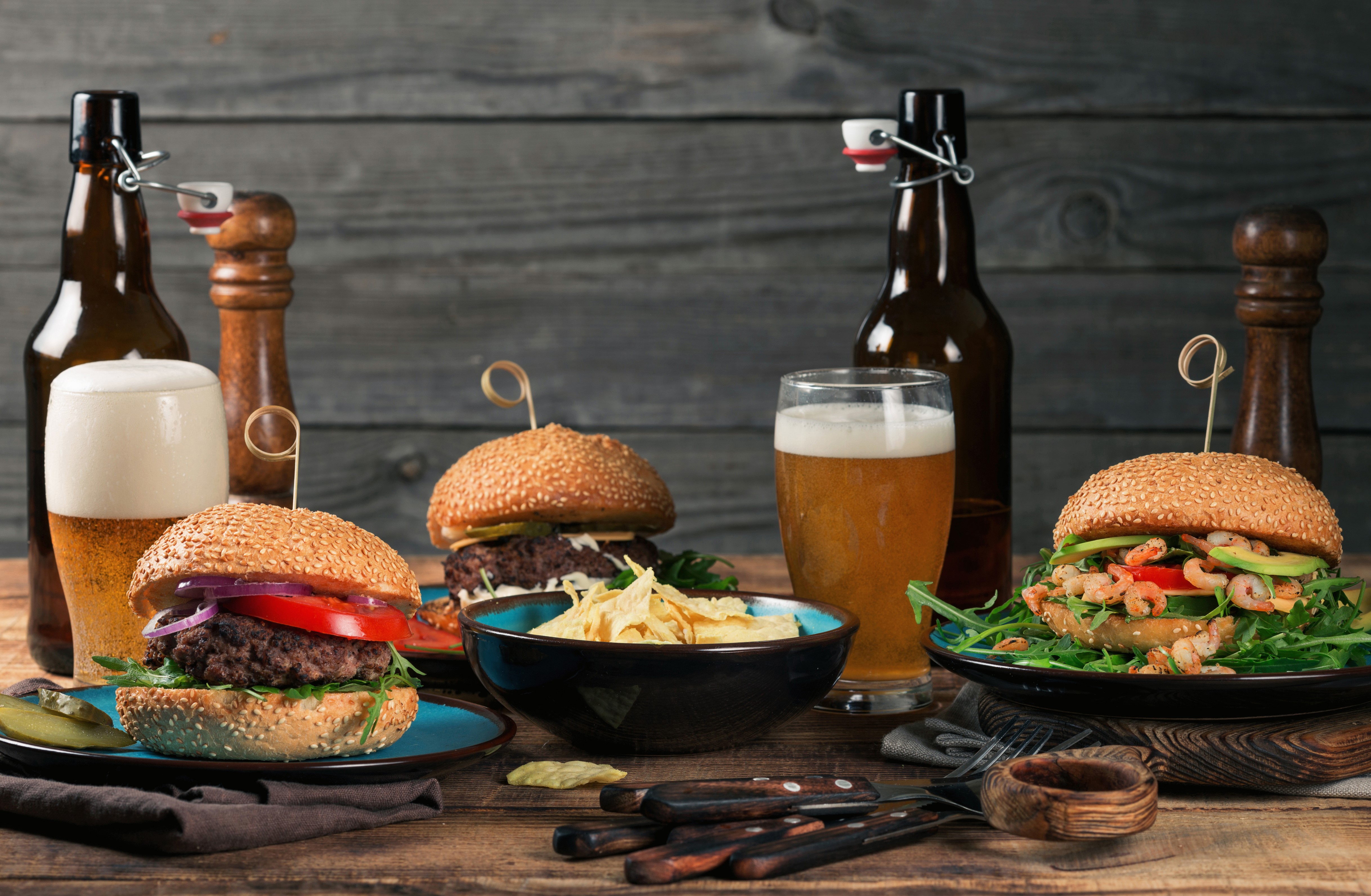 Two hamburgers with beer and chips HD Wallpaper