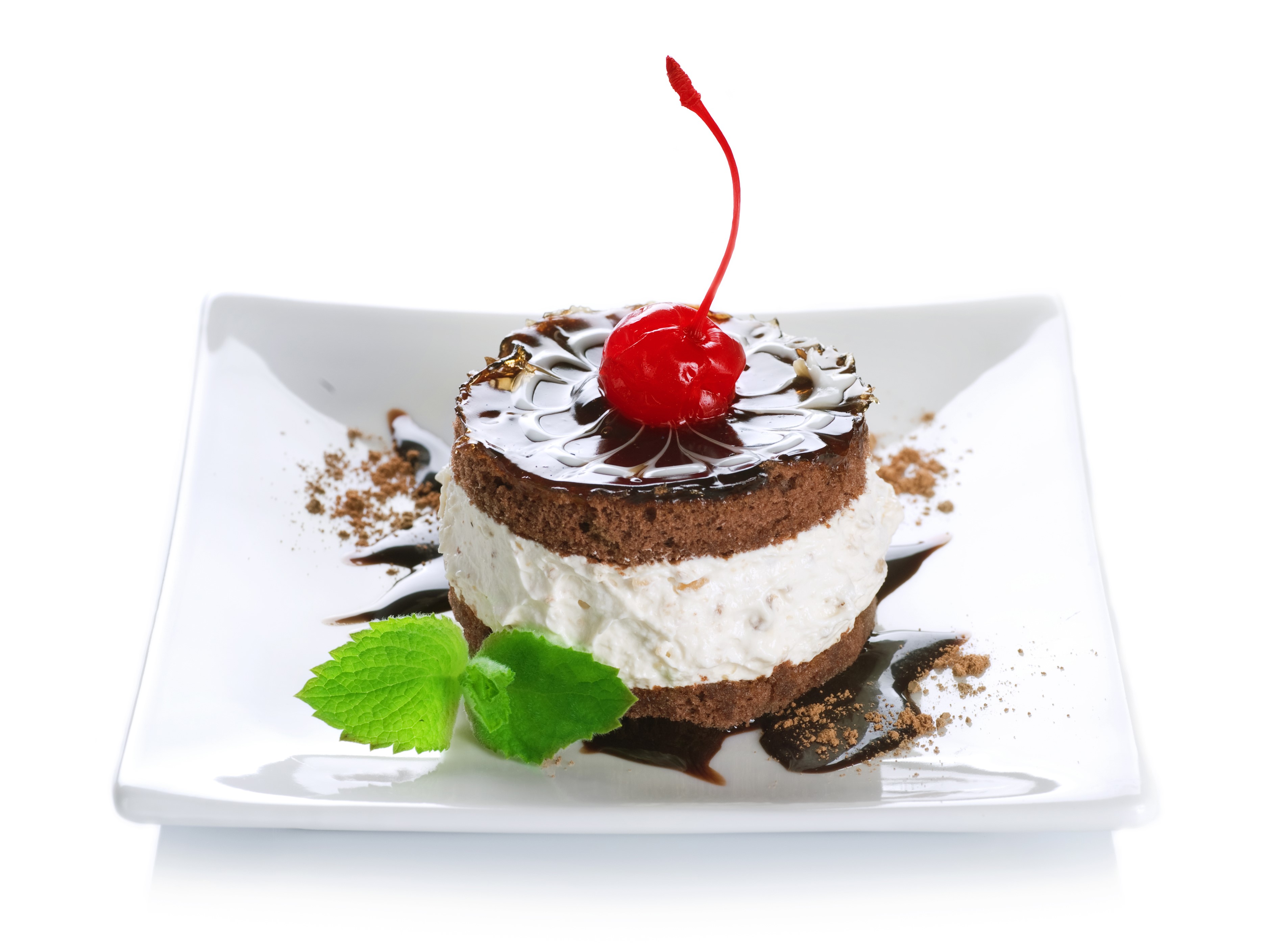 Chocolate cake with cherry and mint on a white plate HD Wallpaper