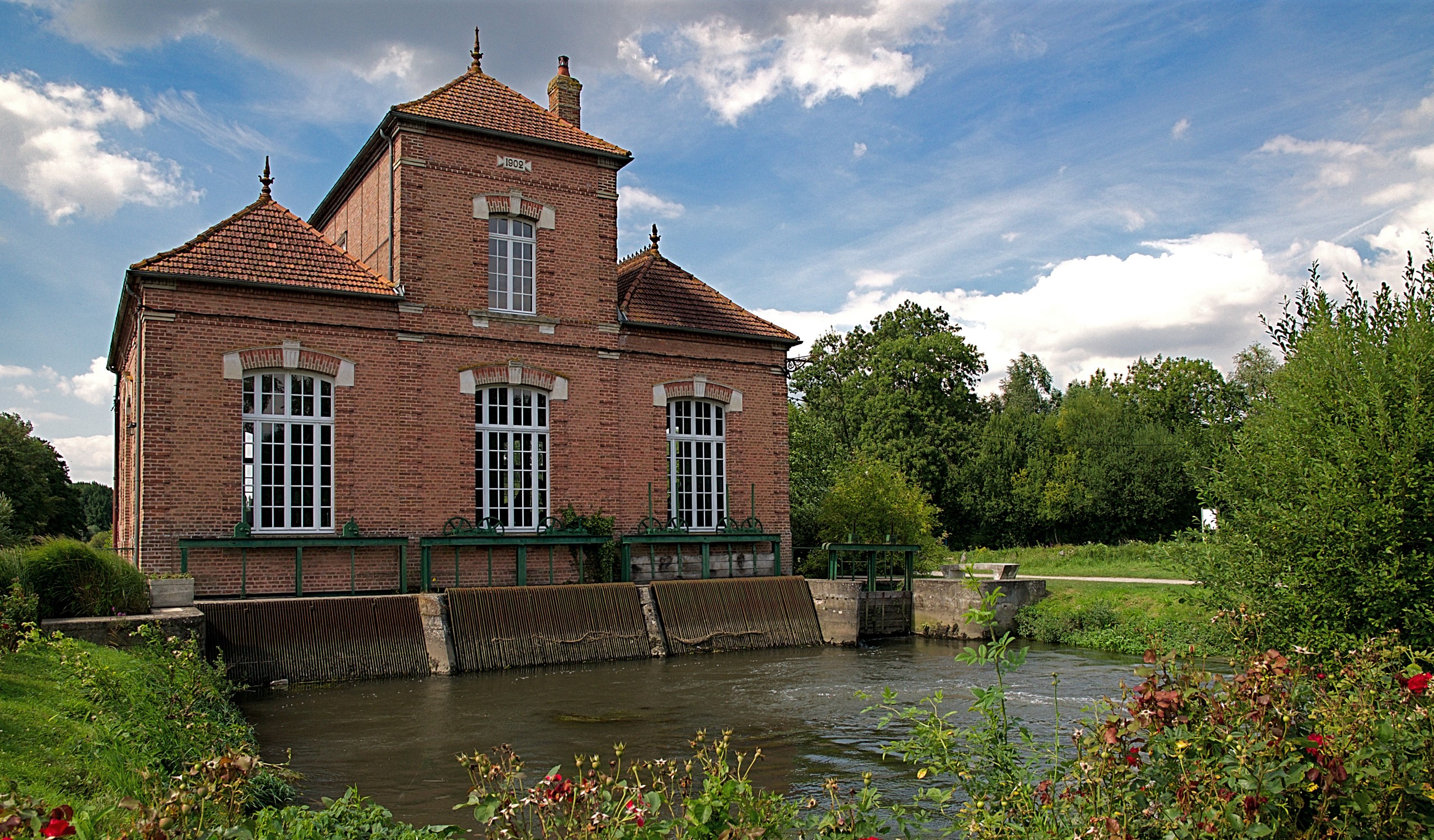 Brick building by a river in Long Picardy, France HD Wallpaper