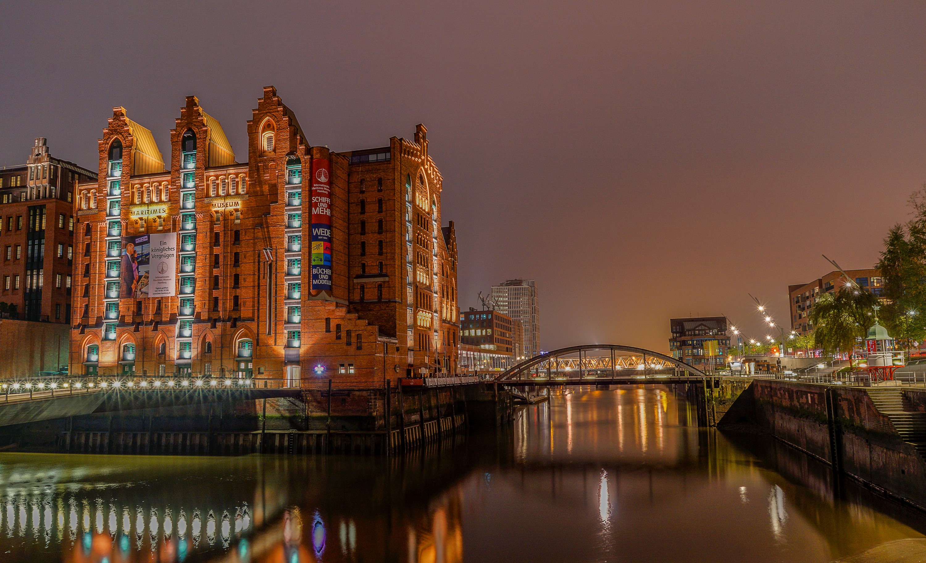 Speicherstadt Hamburg at night with river and bridge HD Wallpaper