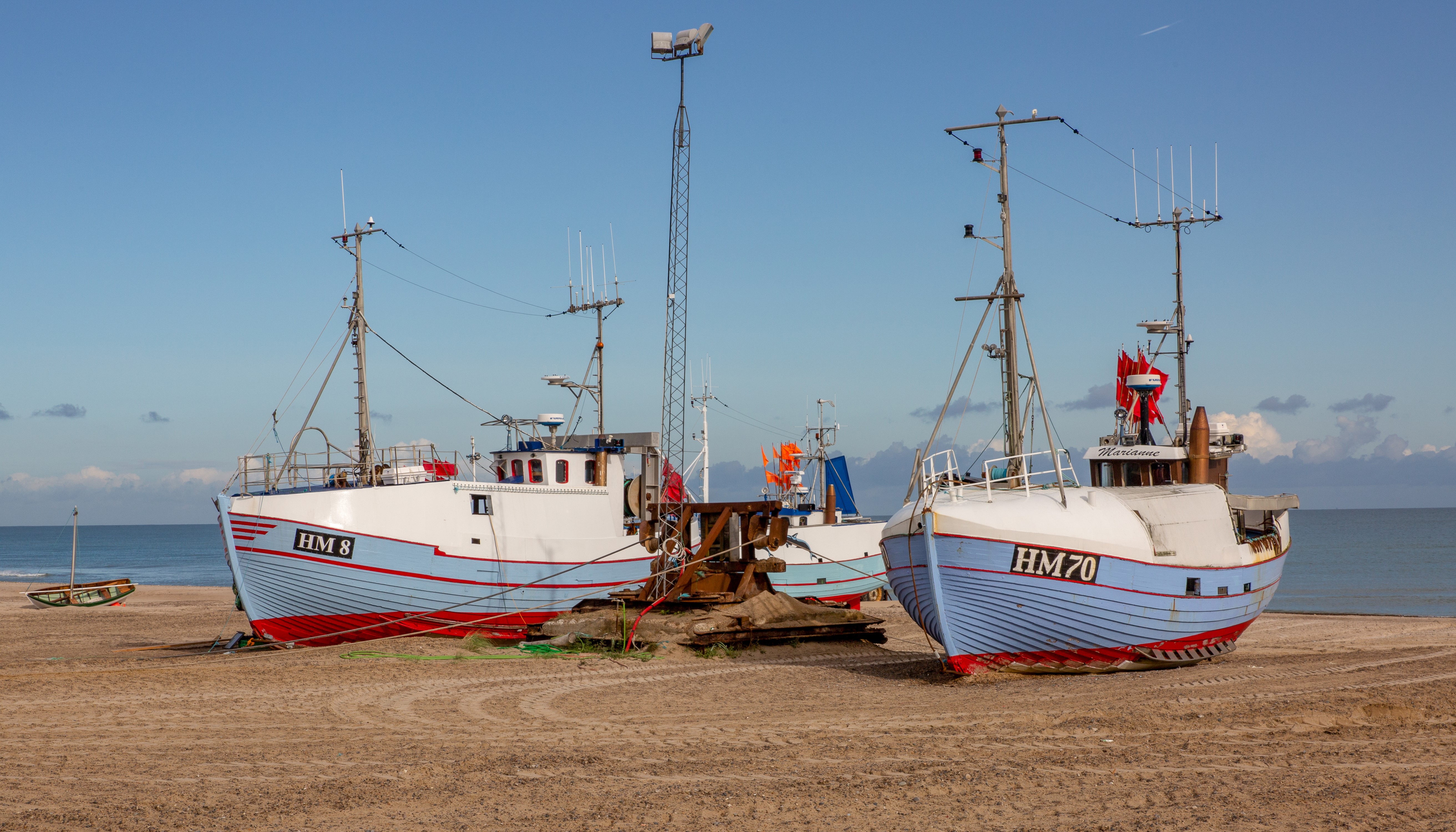 Fishing boats on a sandy beach HD Wallpaper