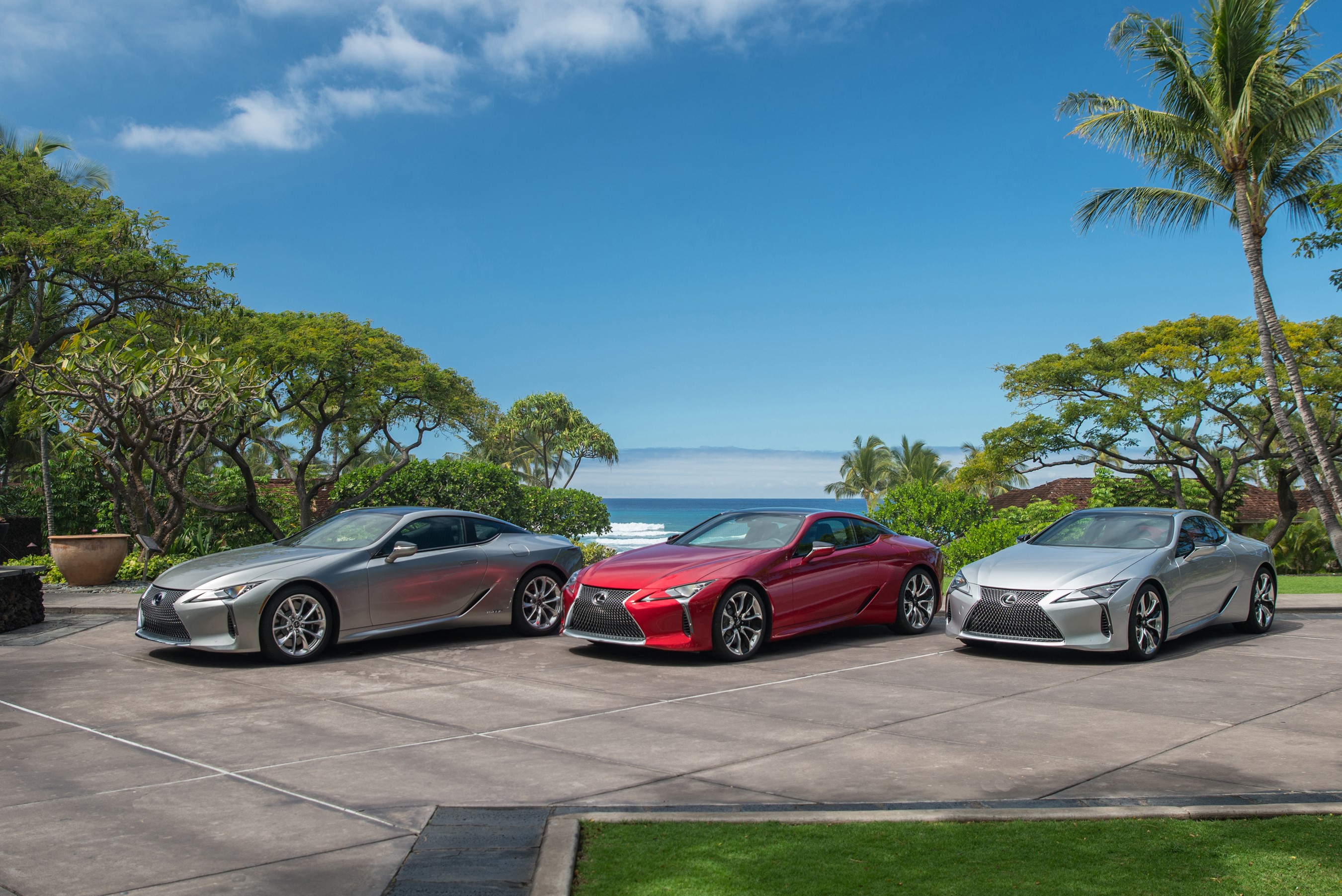 Three Lexus LC cars parked by the ocean HD Wallpaper