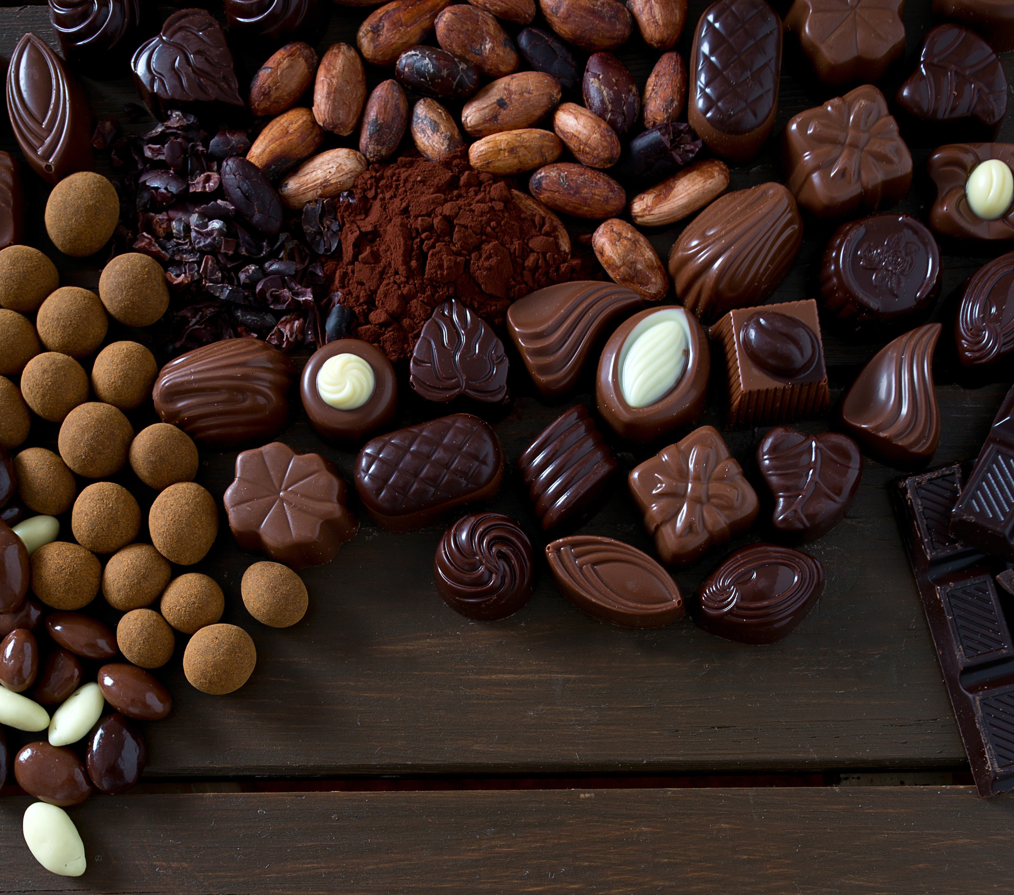 Assortment of chocolates and cocoa beans HD Wallpaper