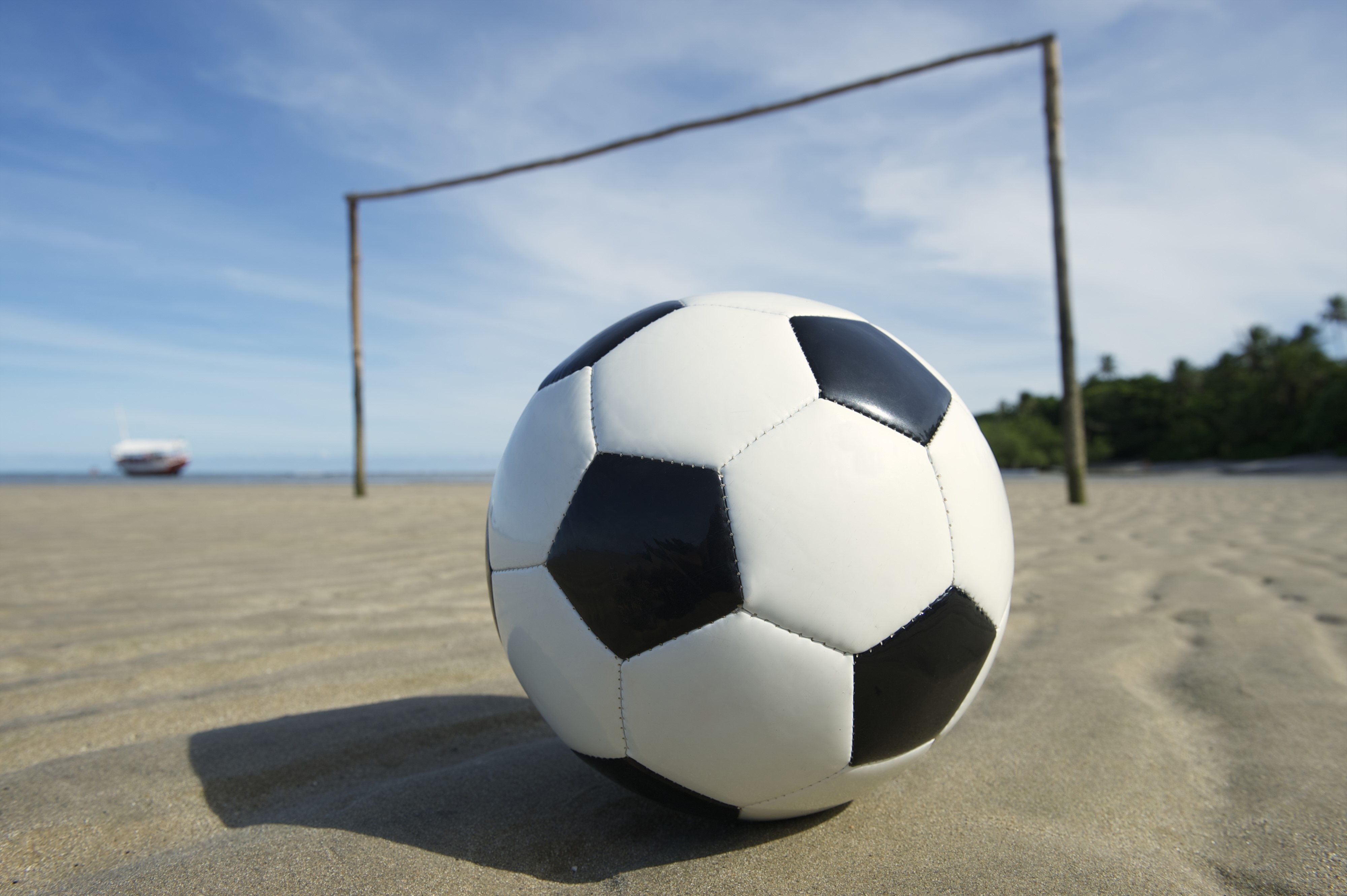 Soccer ball on a beach with goalposts HD Wallpaper