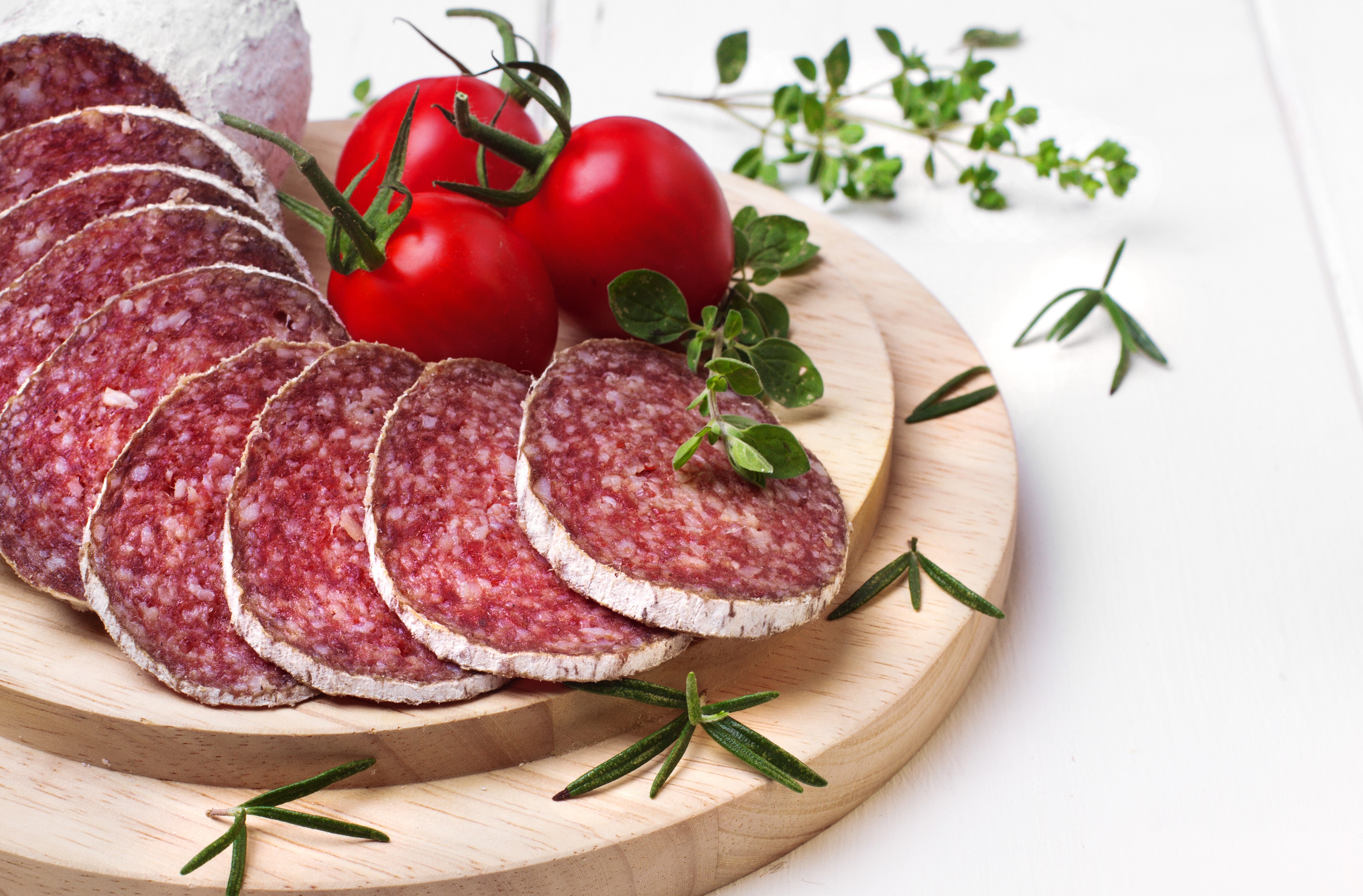 Sliced Sausage with Tomatoes and Herbs on Cutting Board HD Wallpaper