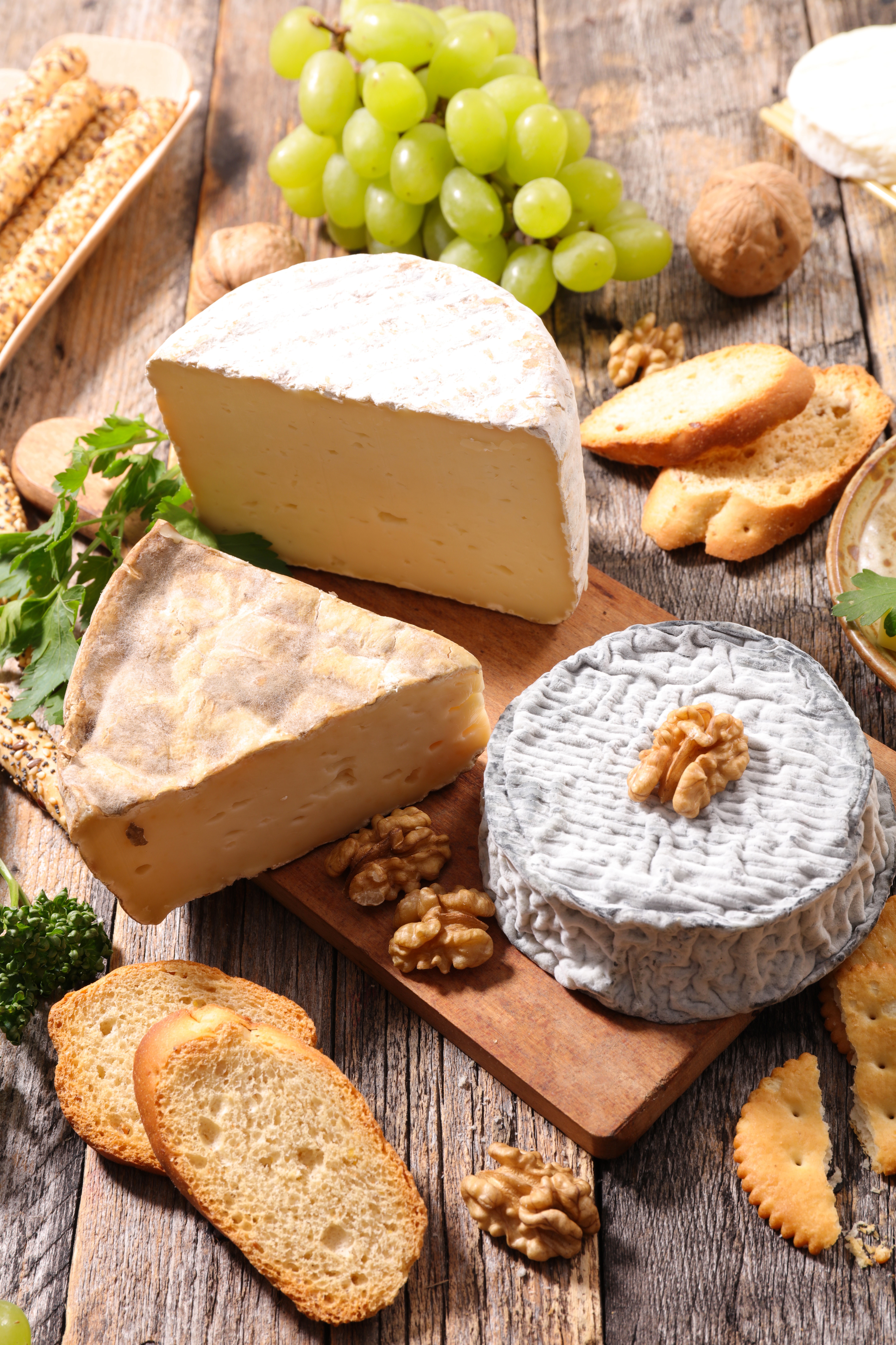 Cheese, Grapes, Nuts, and Bread on a Cutting Board HD Phone Wallpaper