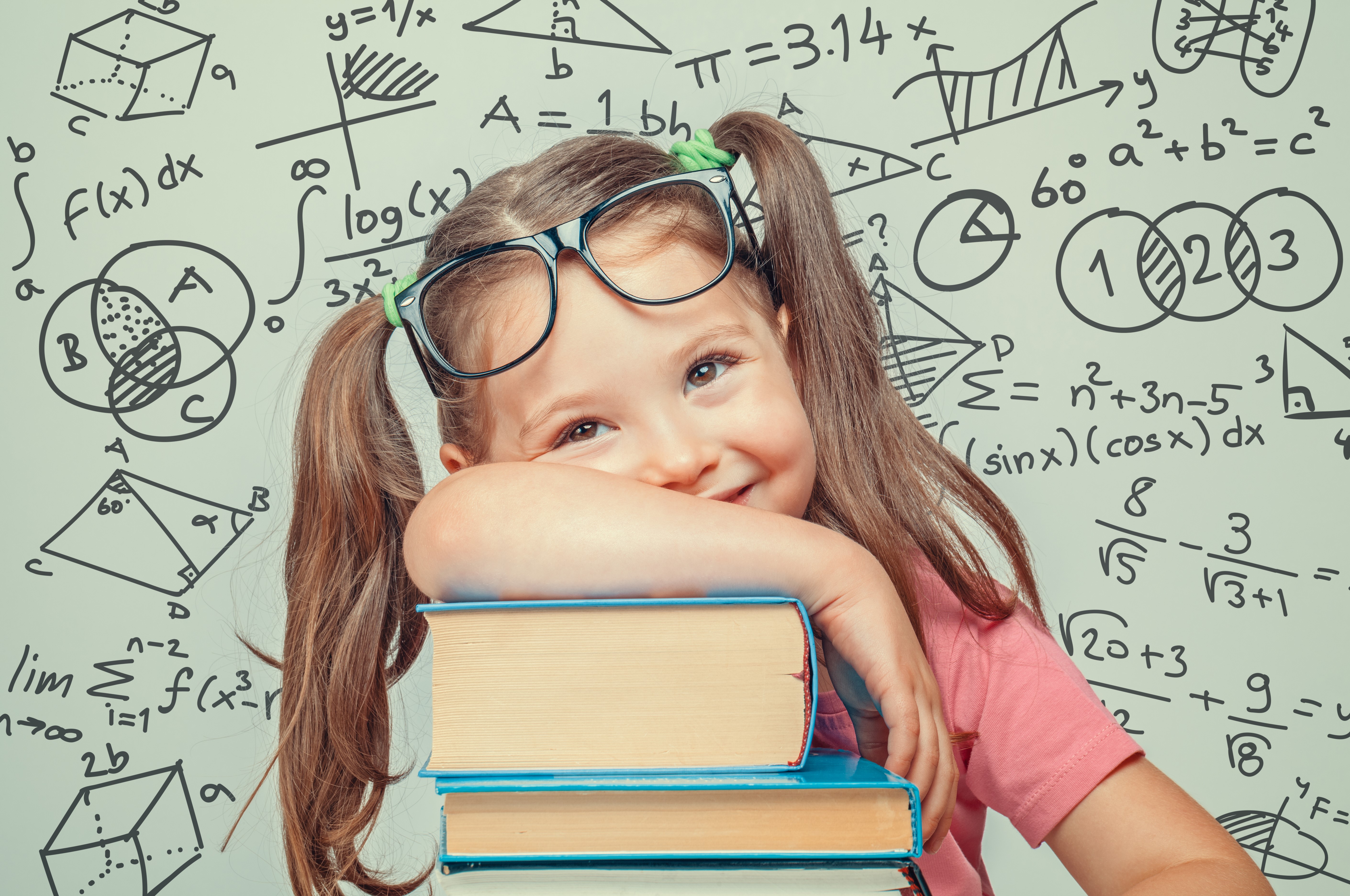 Little girl with glasses and books in front of math equations HD Wallpaper