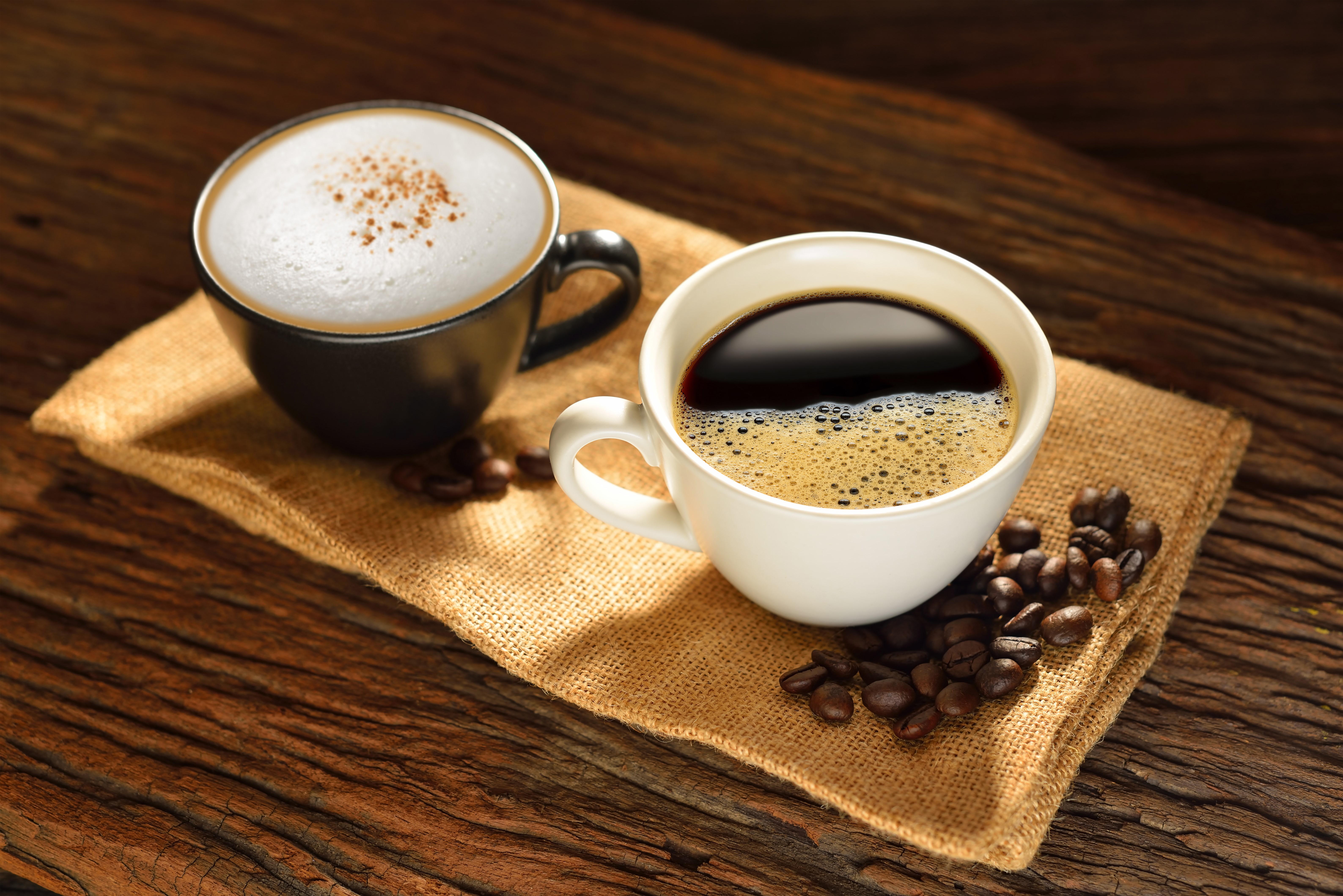 Two cups of coffee and cappuccino with coffee beans HD Wallpaper
