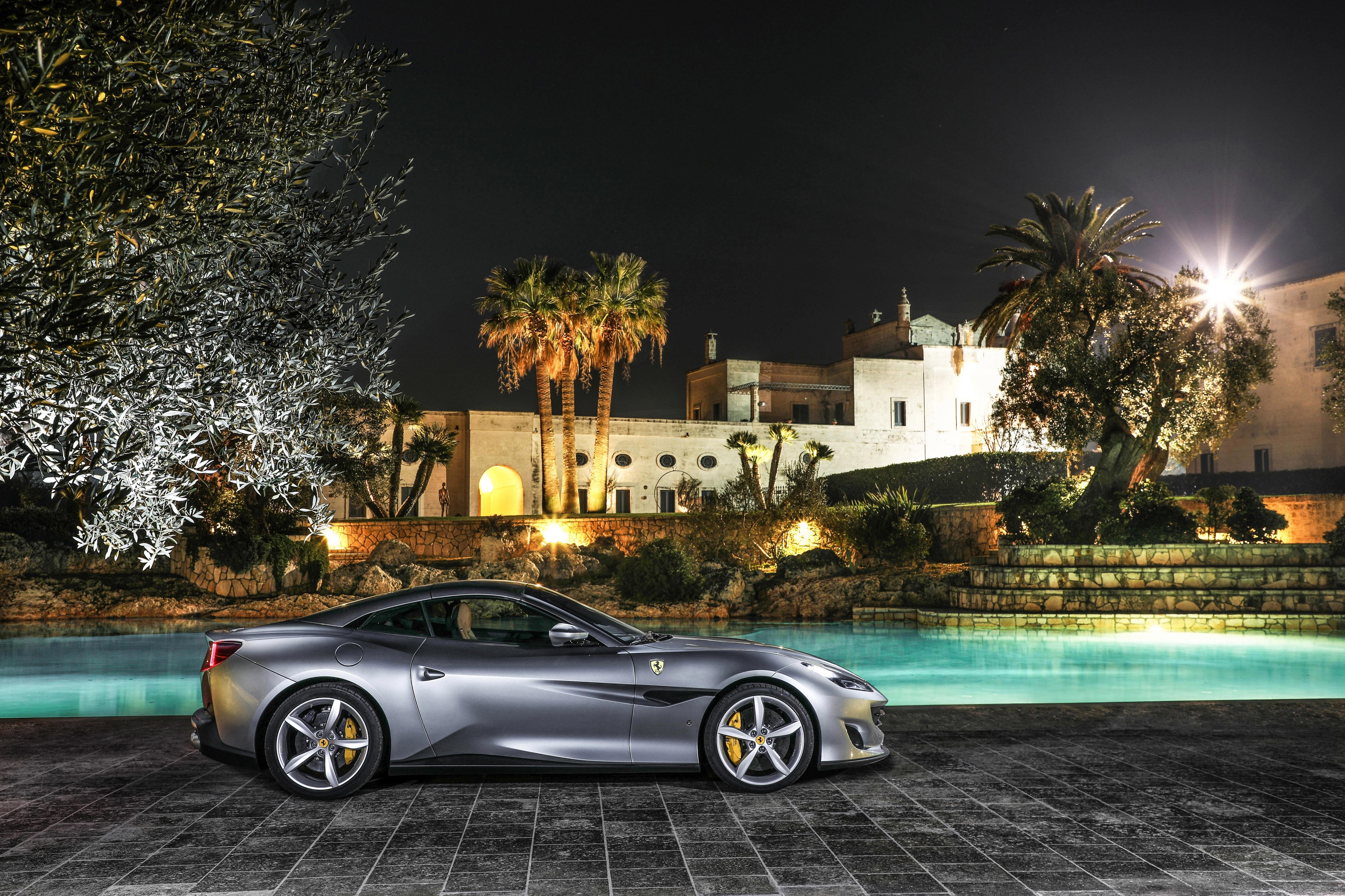 Grey 2018 Ferrari Portofino parked by a pool at night HD Wallpaper