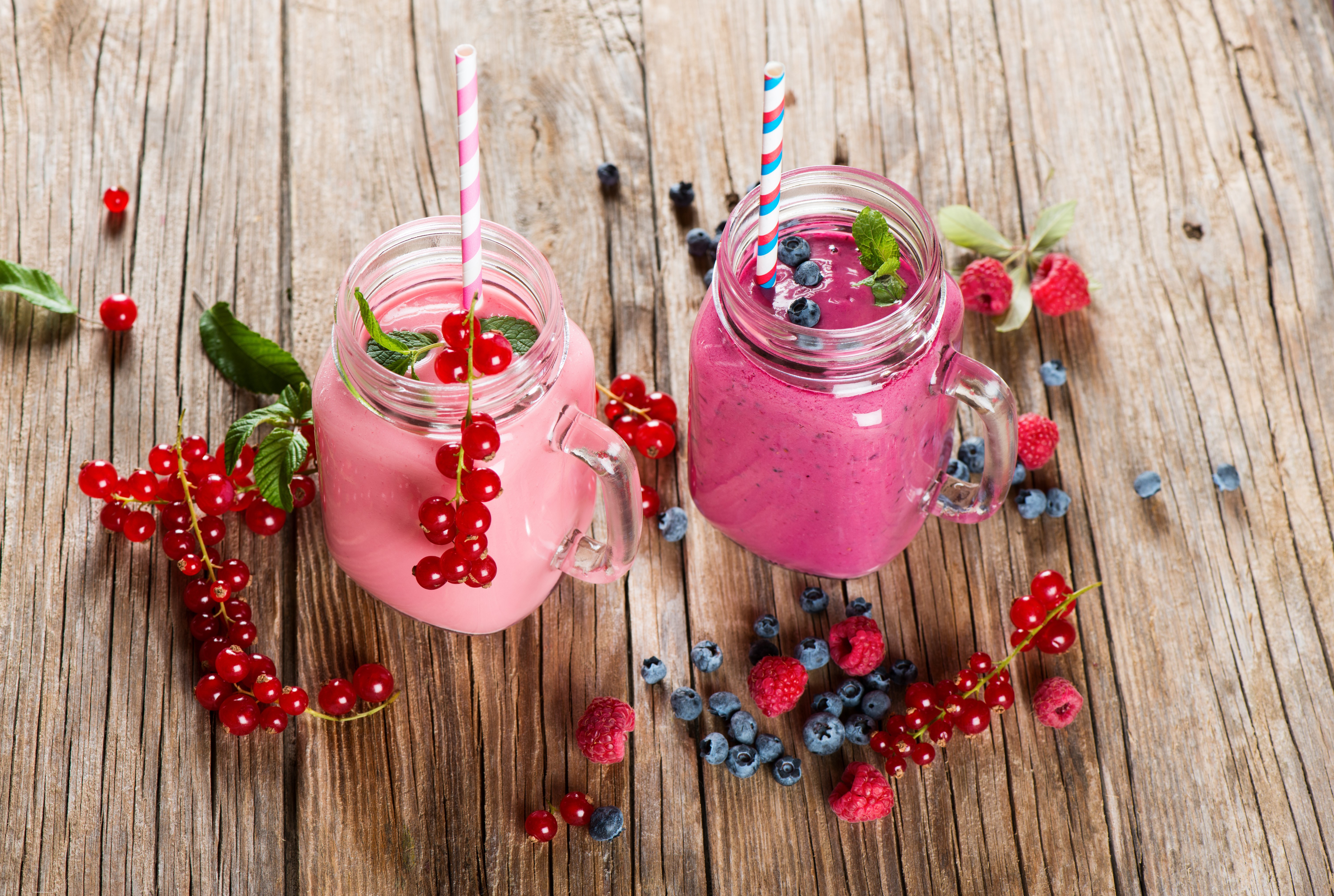 Two berry smoothies with fresh berries on wood HD Wallpaper