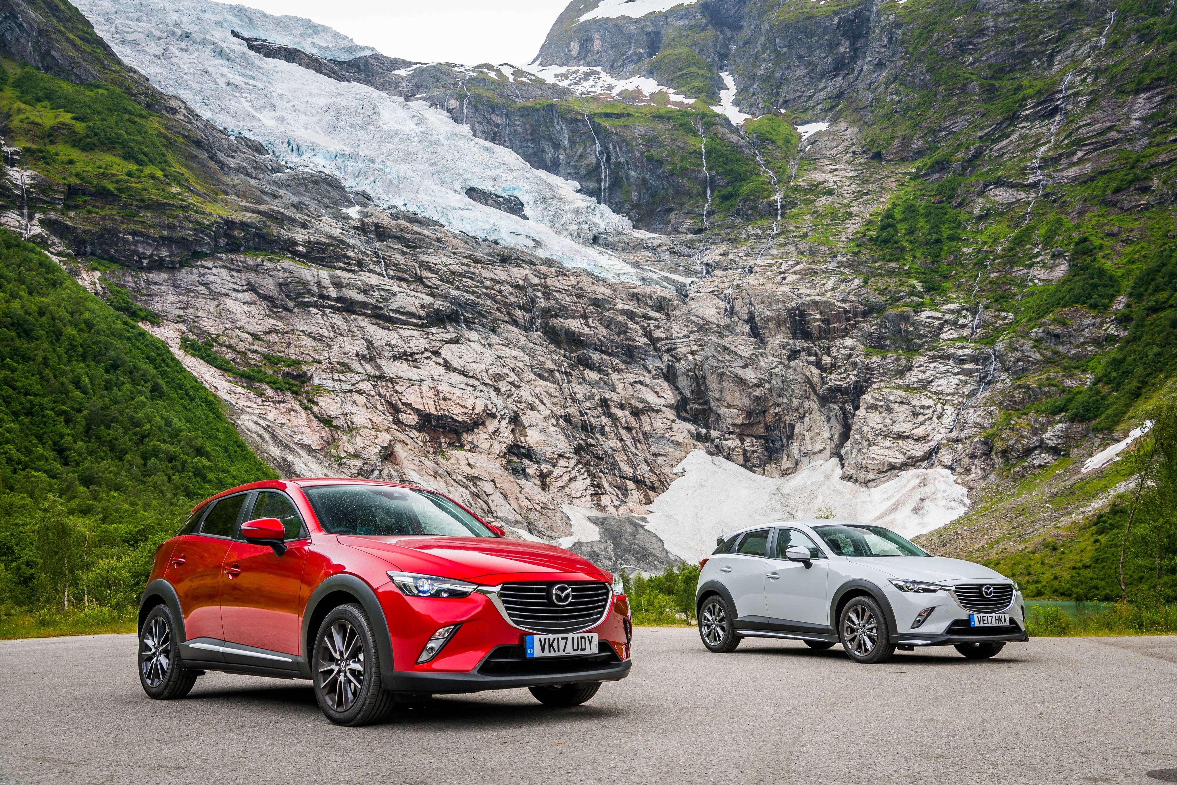 Two Mazda CX-3 cars in front of a glacier HD Wallpaper