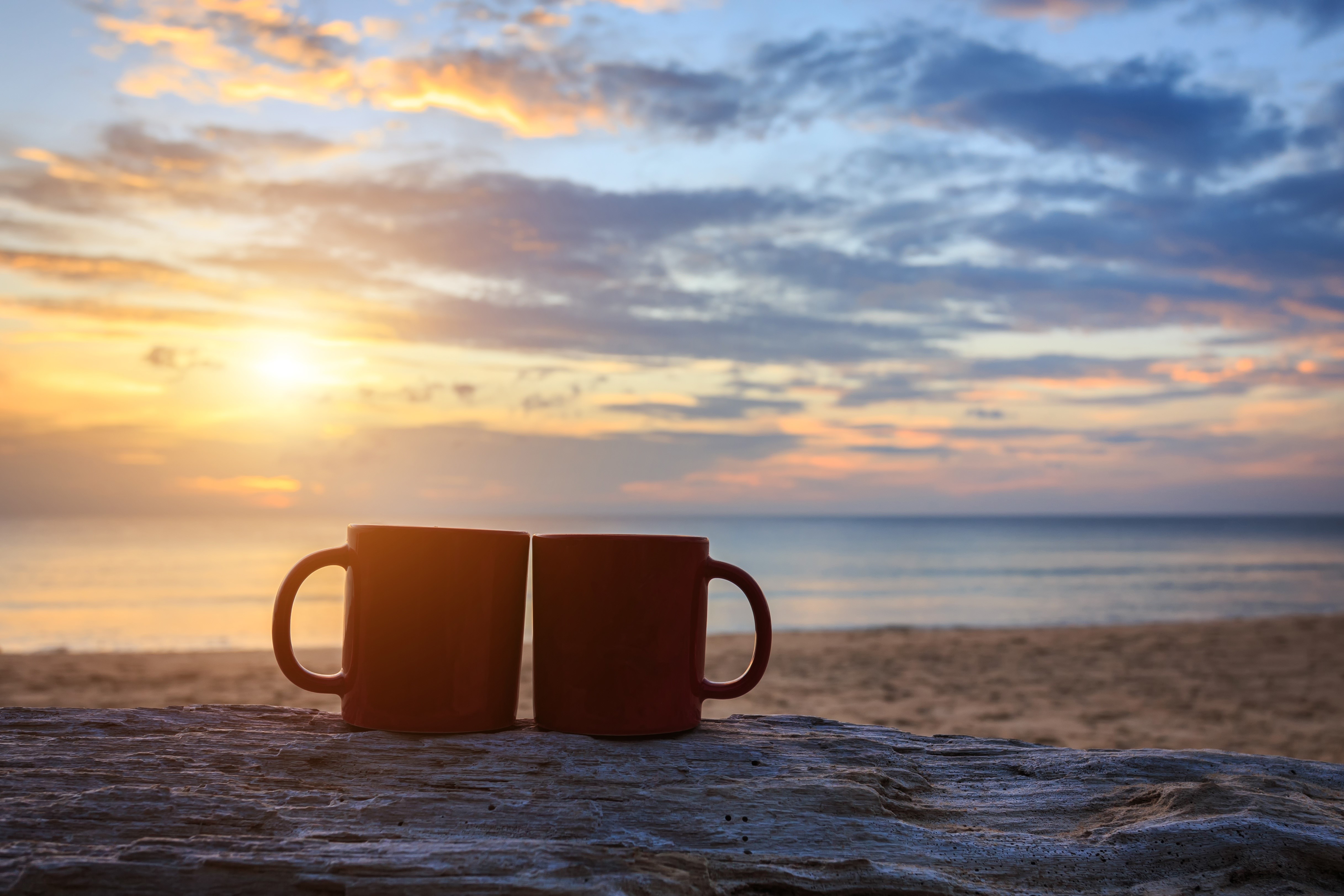 Two mugs on a beach at sunset HD Wallpaper