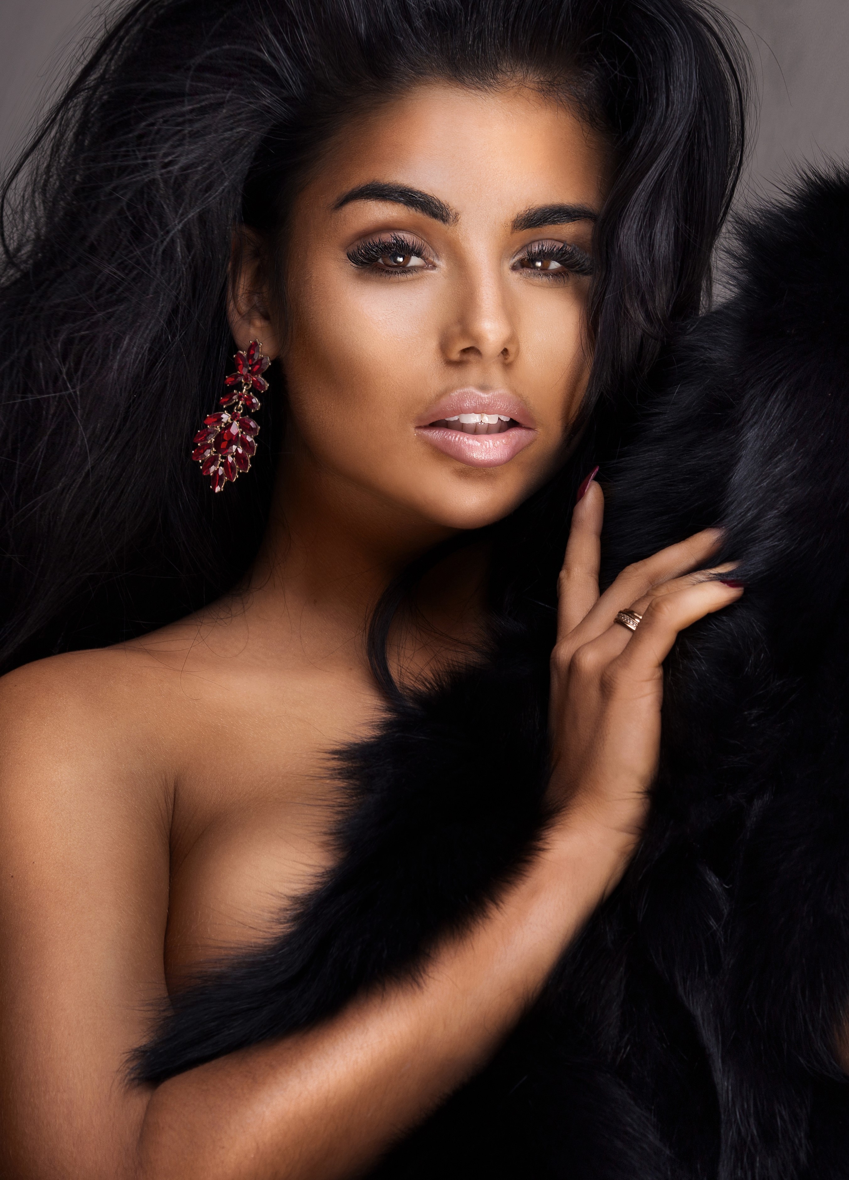 Woman with dark hair and red earrings HD Phone Wallpaper