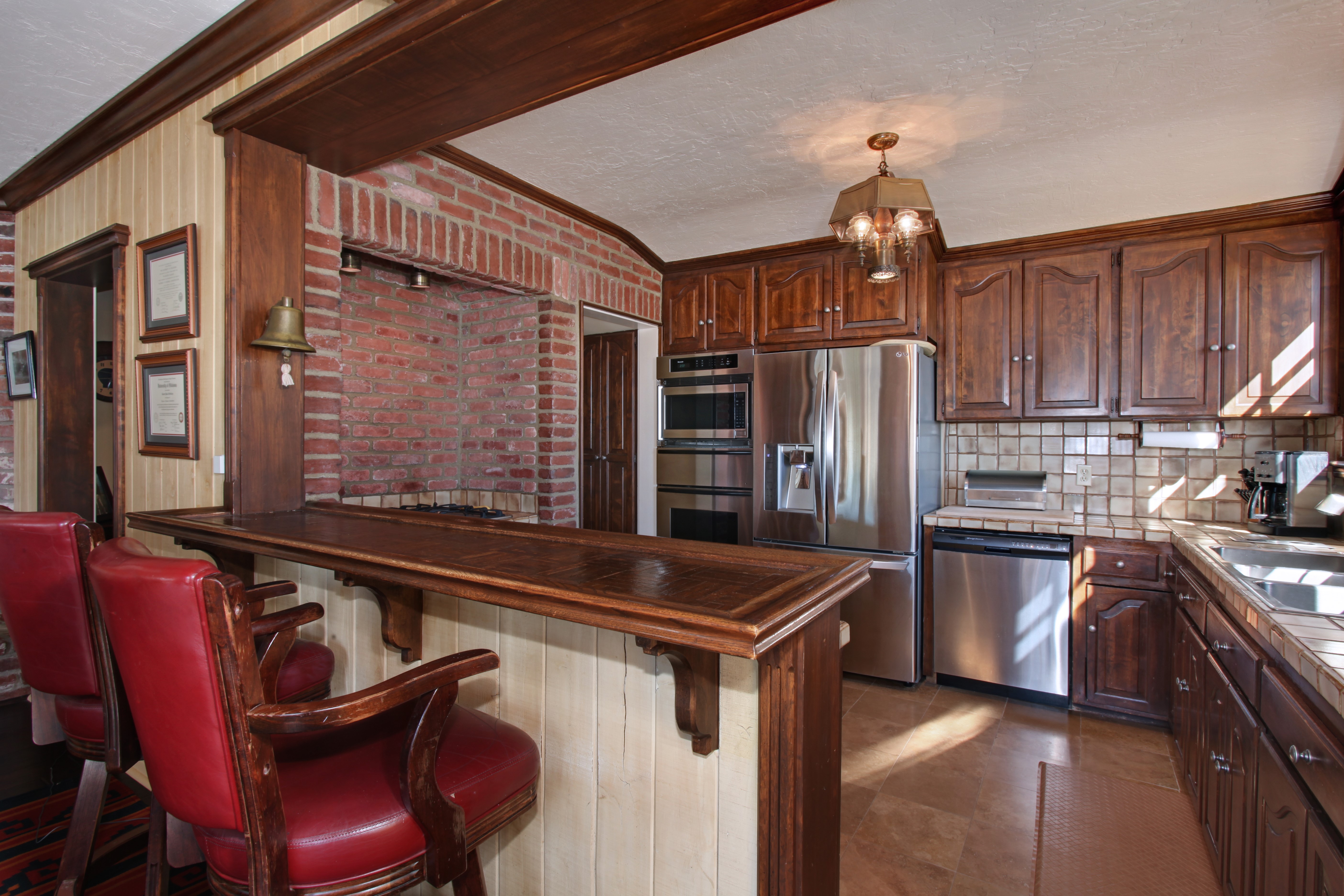 Kitchen with Bar and Brick Fireplace HD Wallpaper