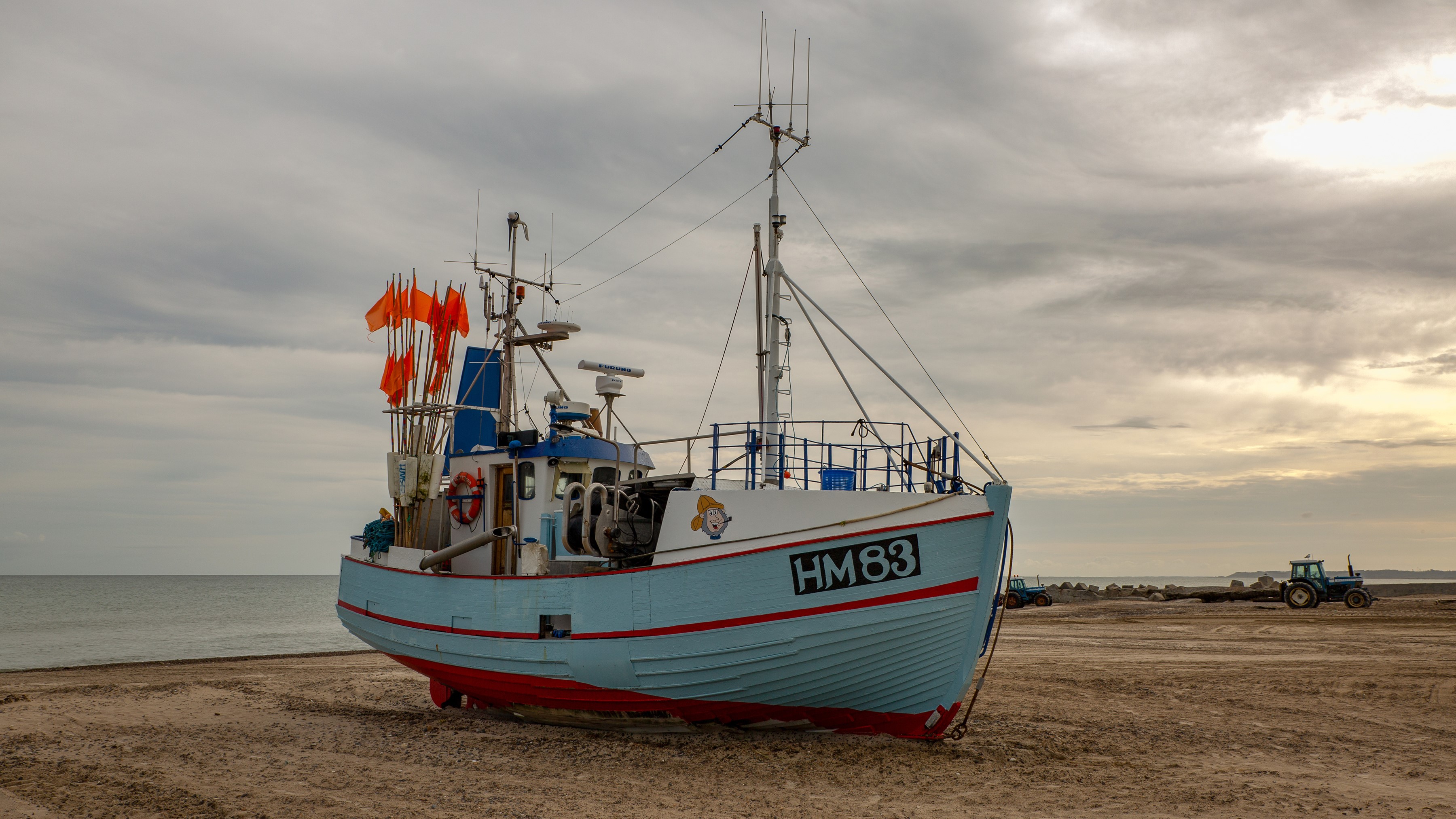 Fishing boat HM83 on a sandy beach HD Wallpaper