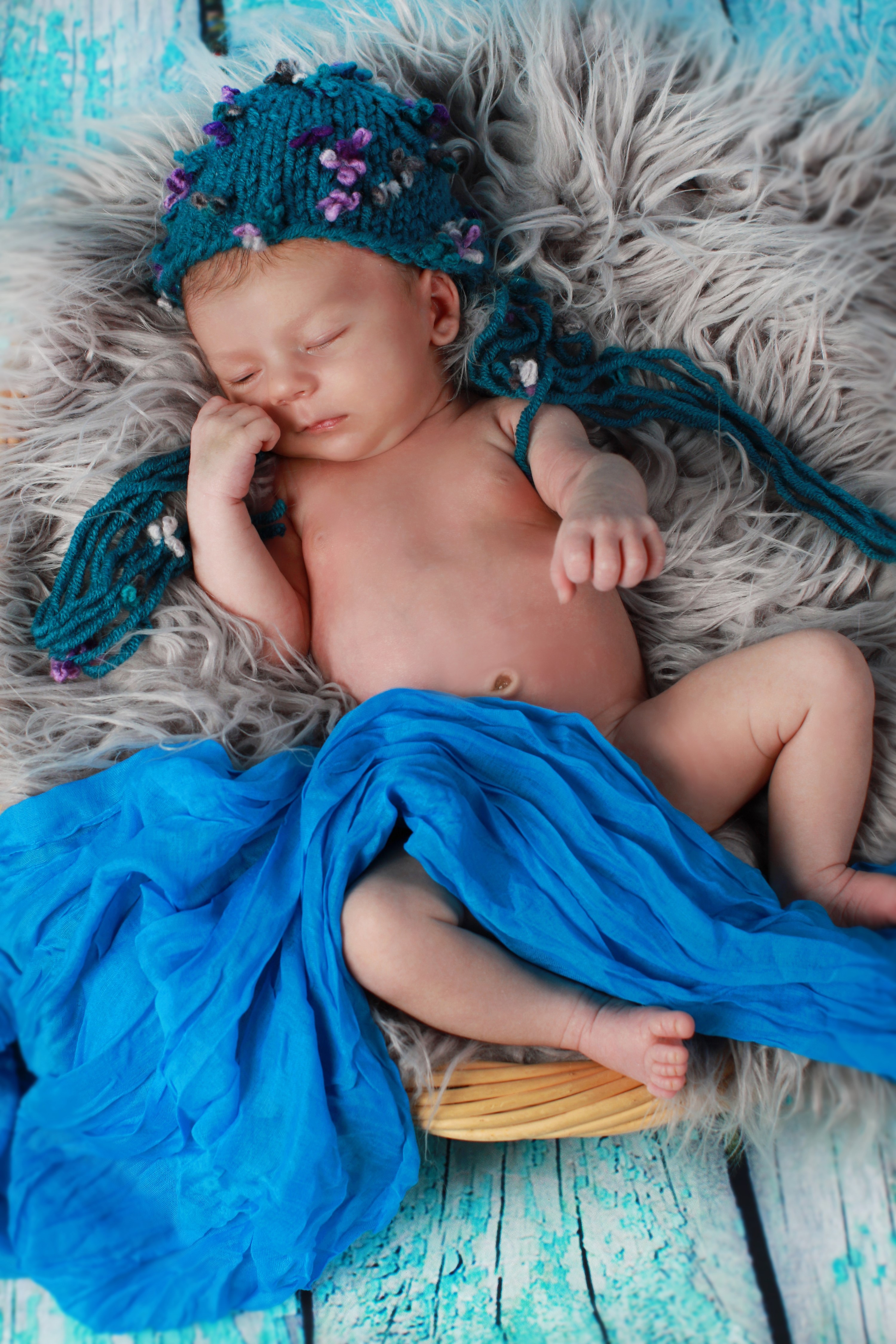 Newborn baby sleeping in a teal hat HD Phone Wallpaper