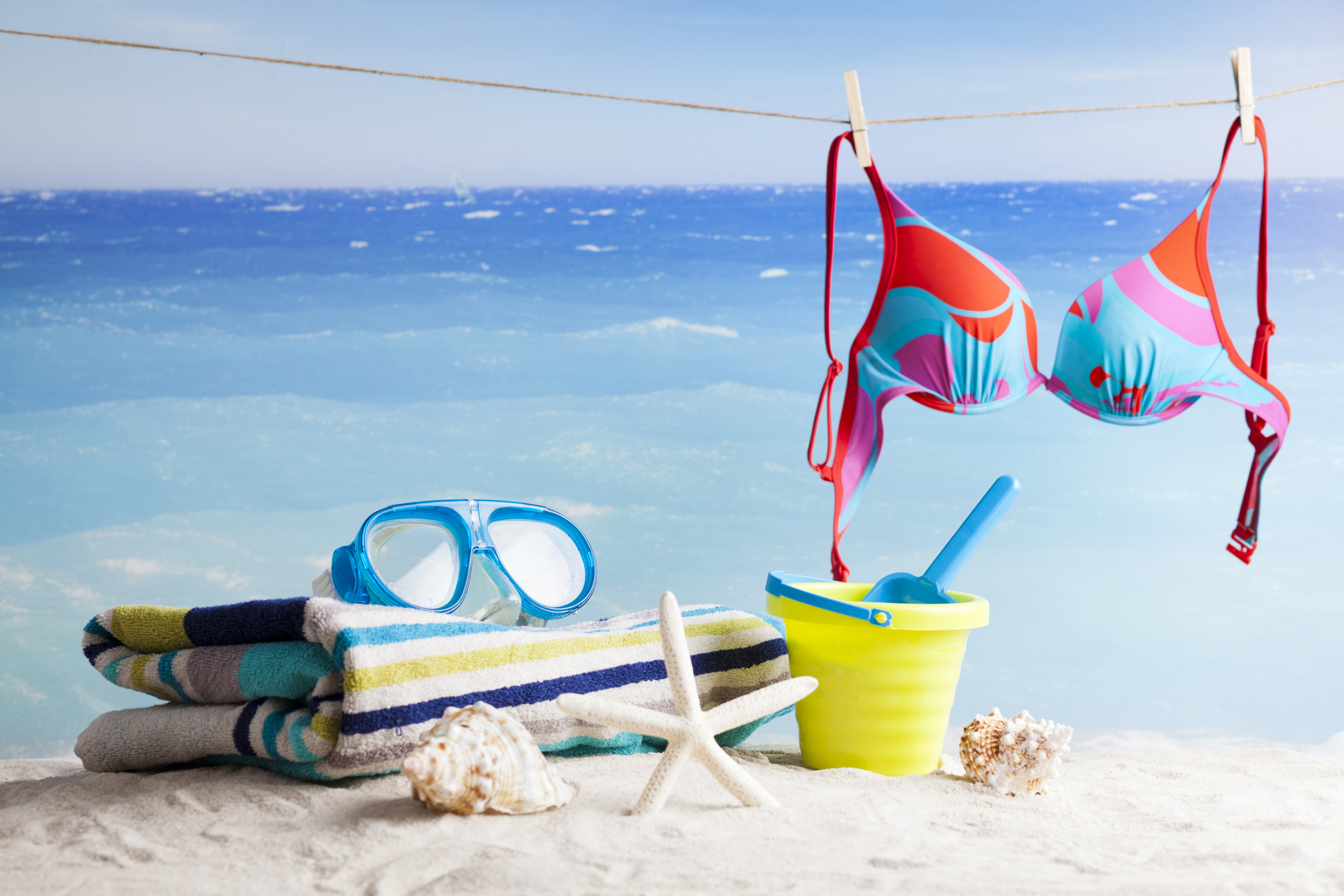 Beach scene with bikini, towels, and goggles HD Wallpaper