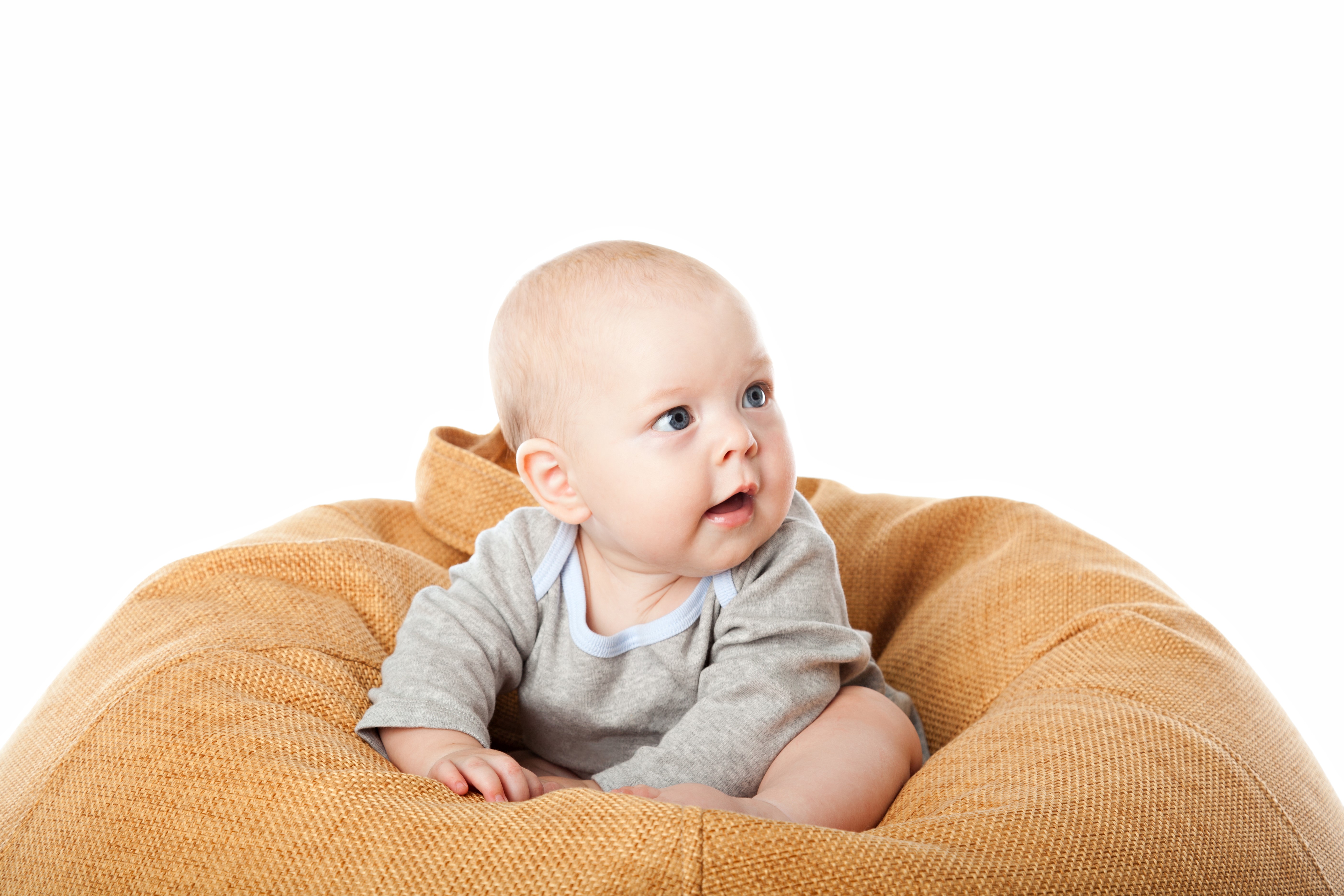 Infant sitting on a beanbag chair HD Wallpaper
