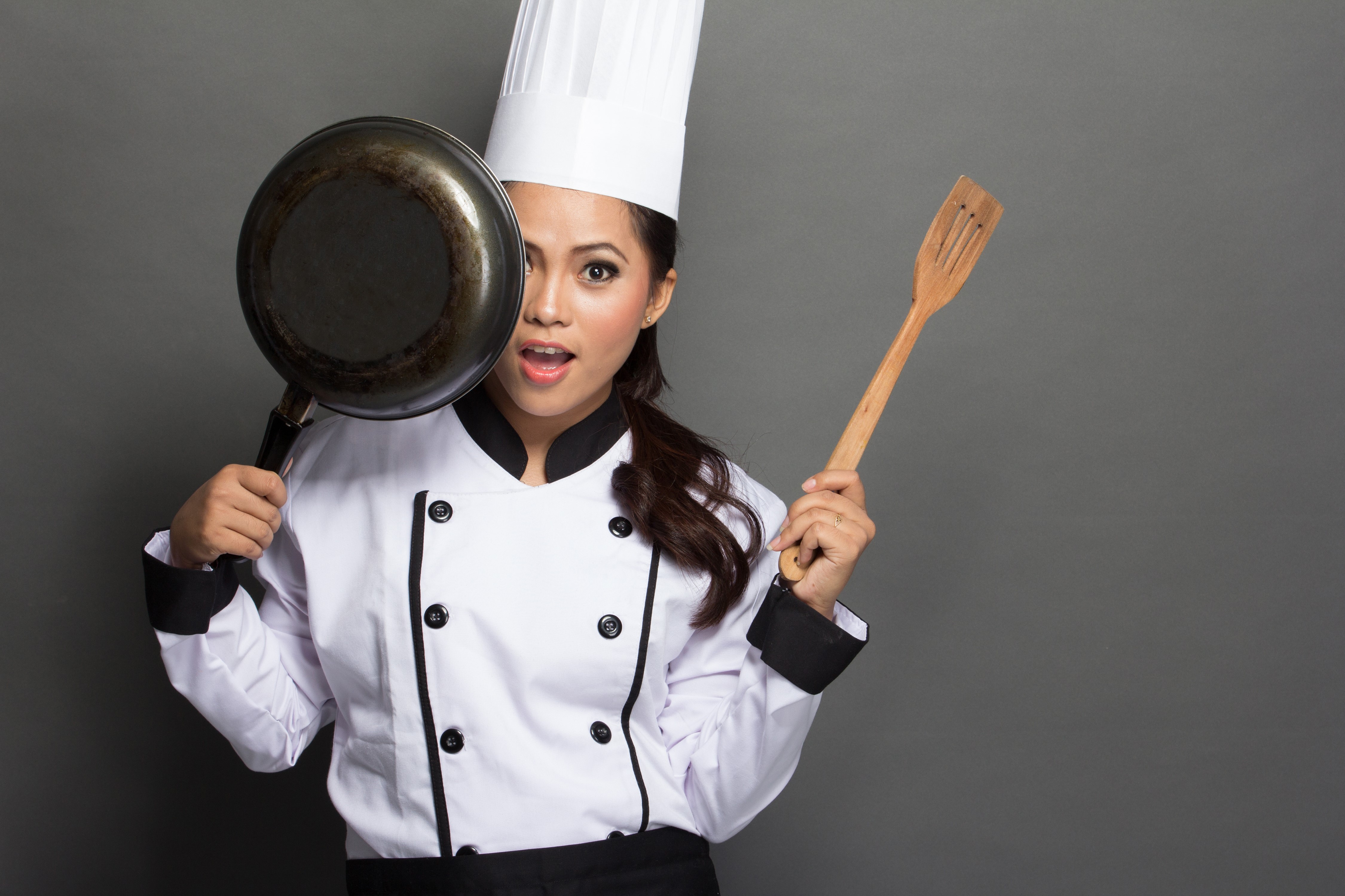 Chef holding a frying pan and spatula HD Wallpaper