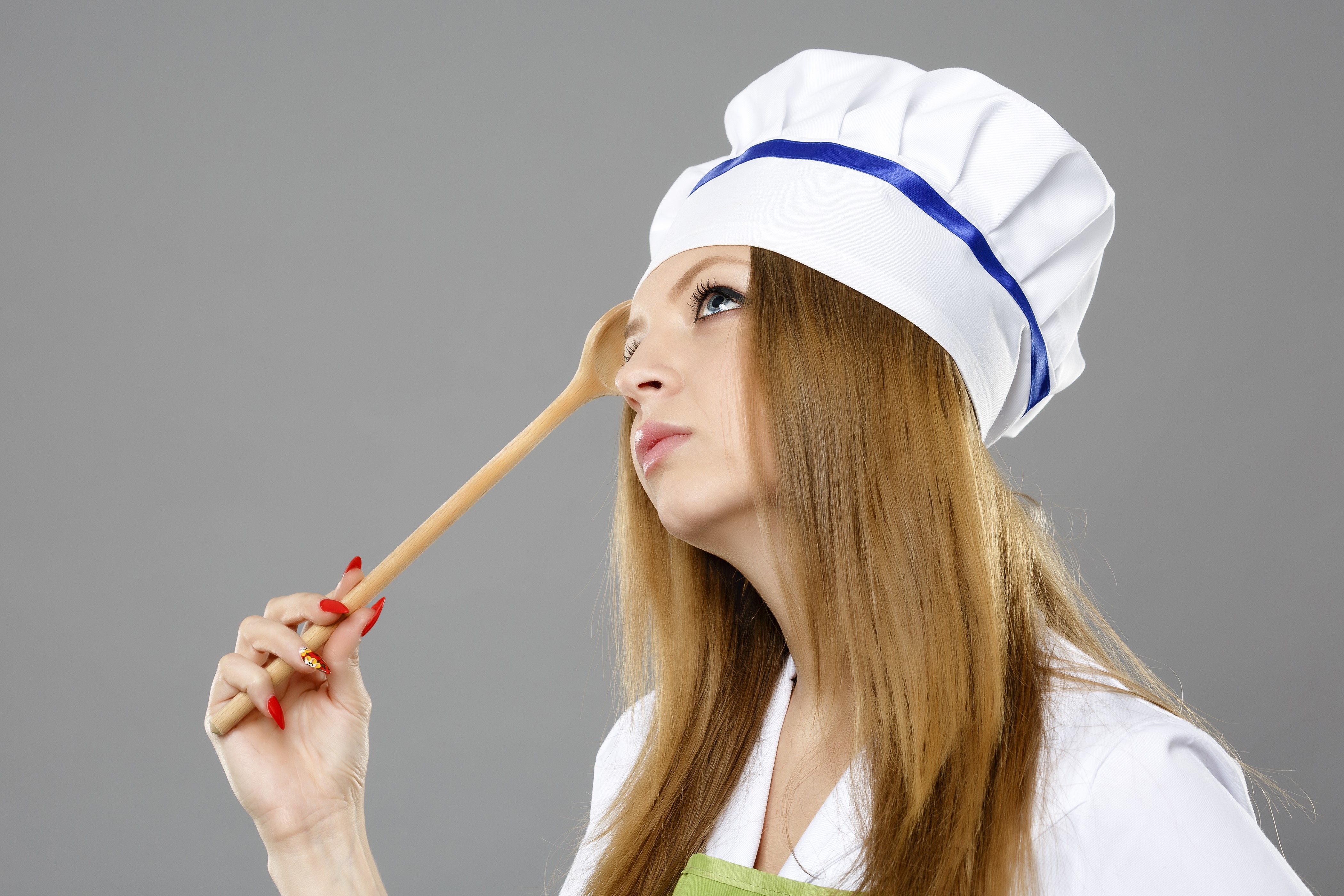 Woman in chef's hat holding wooden spoon HD Wallpaper