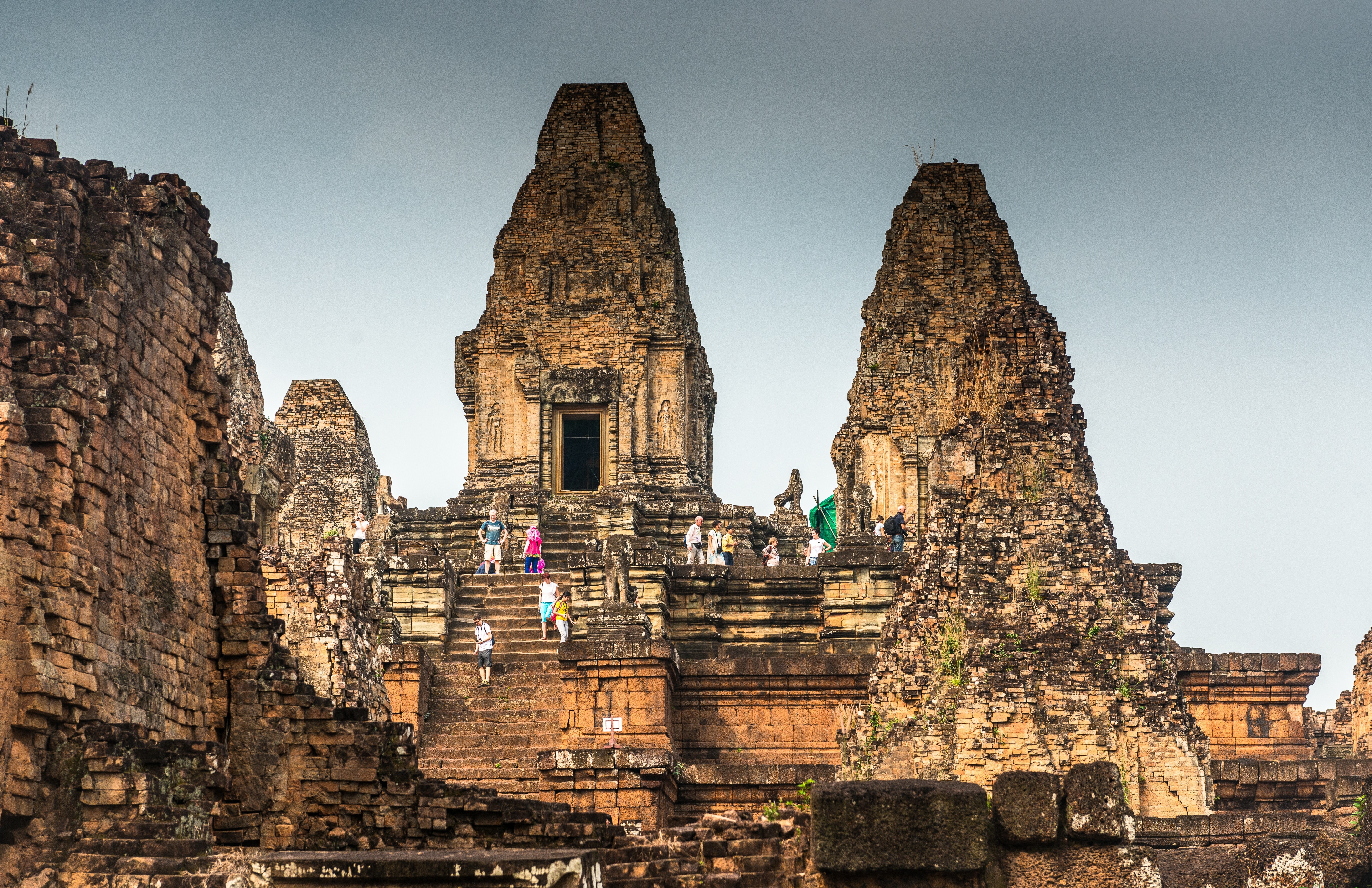 Angkor Wat ruins in Cambodia with tourists on stairs HD Wallpaper