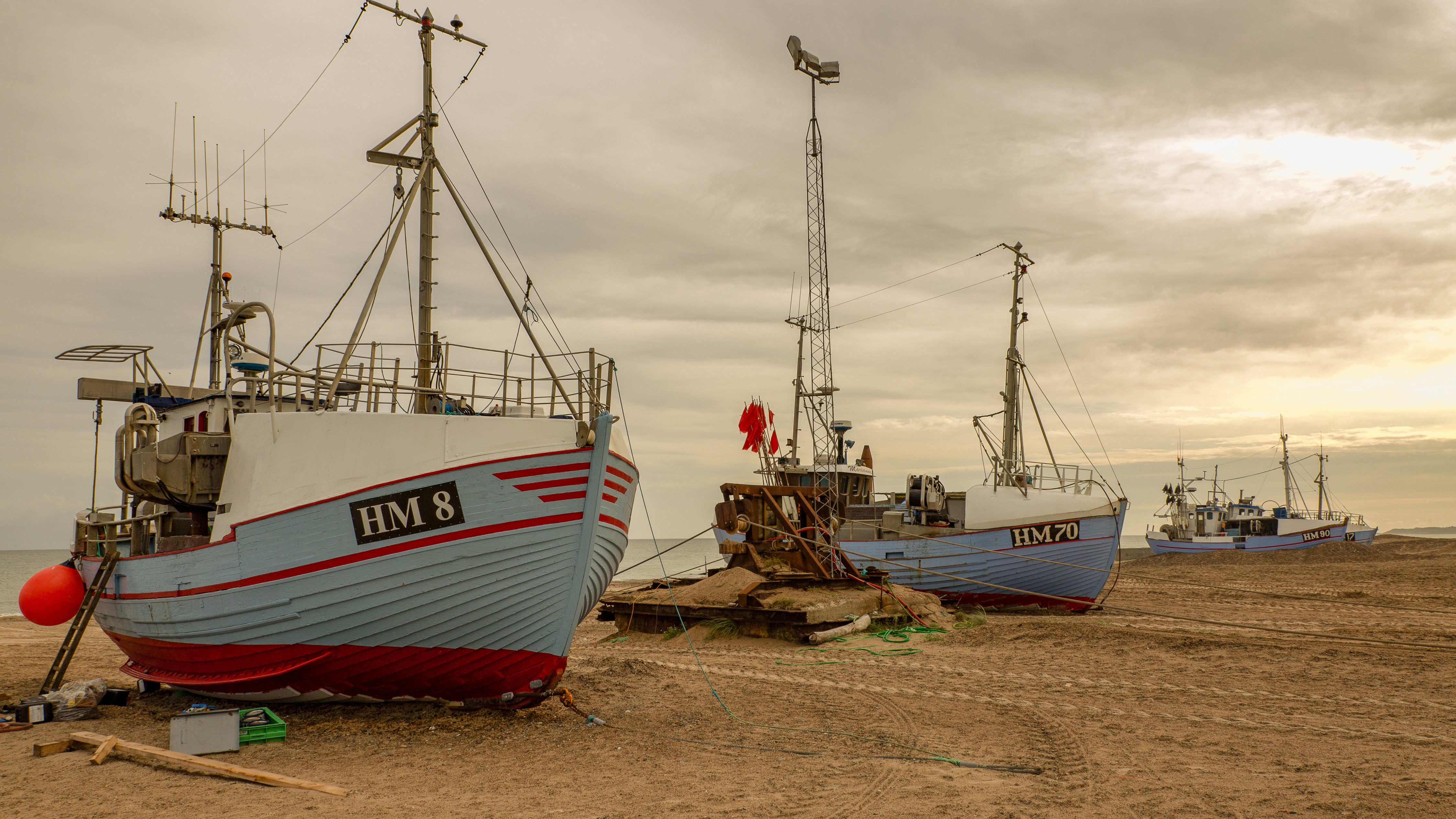 Fishing boats on a sandy coast HD Wallpaper