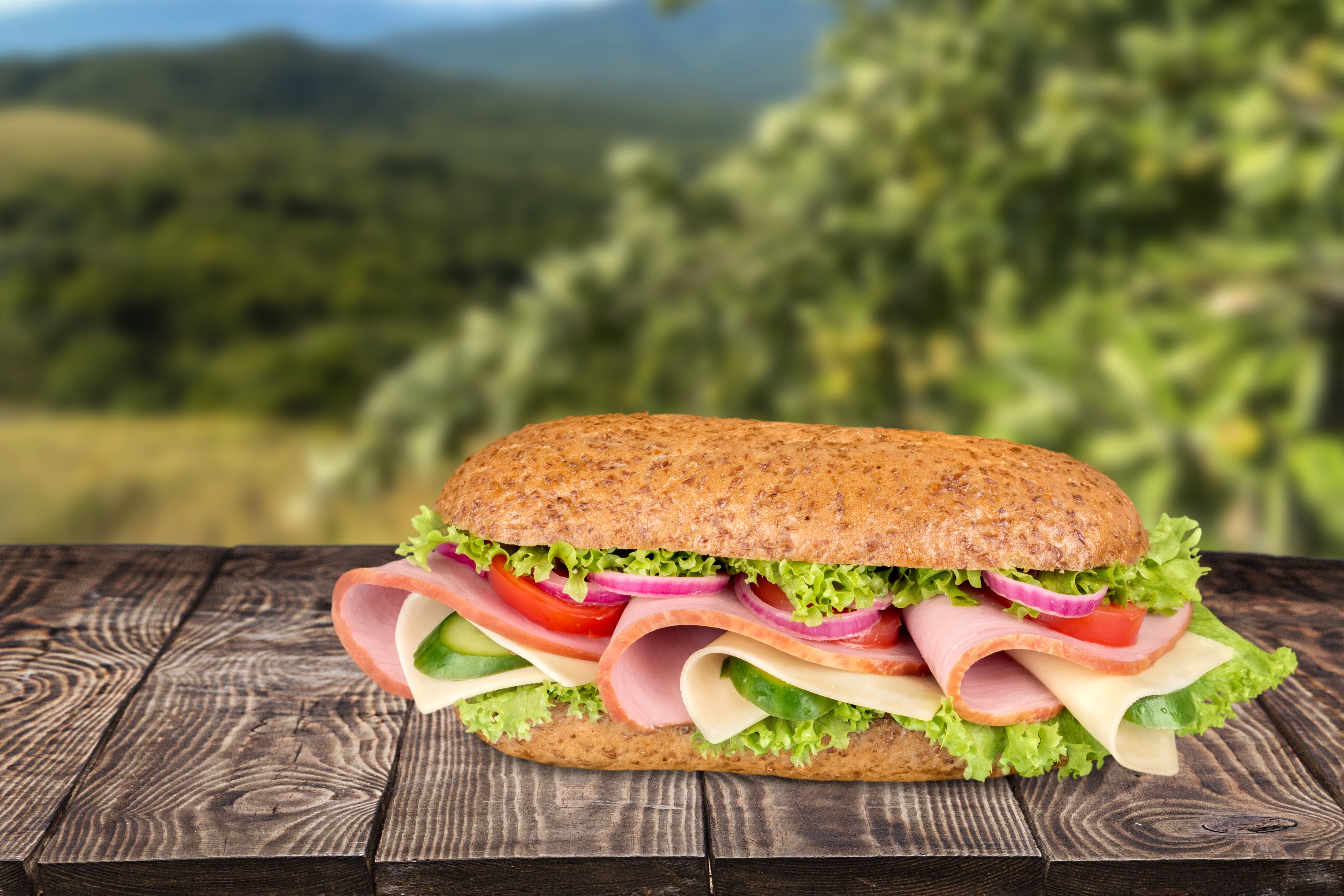 Sandwich on wood planks with blurred background HD Wallpaper