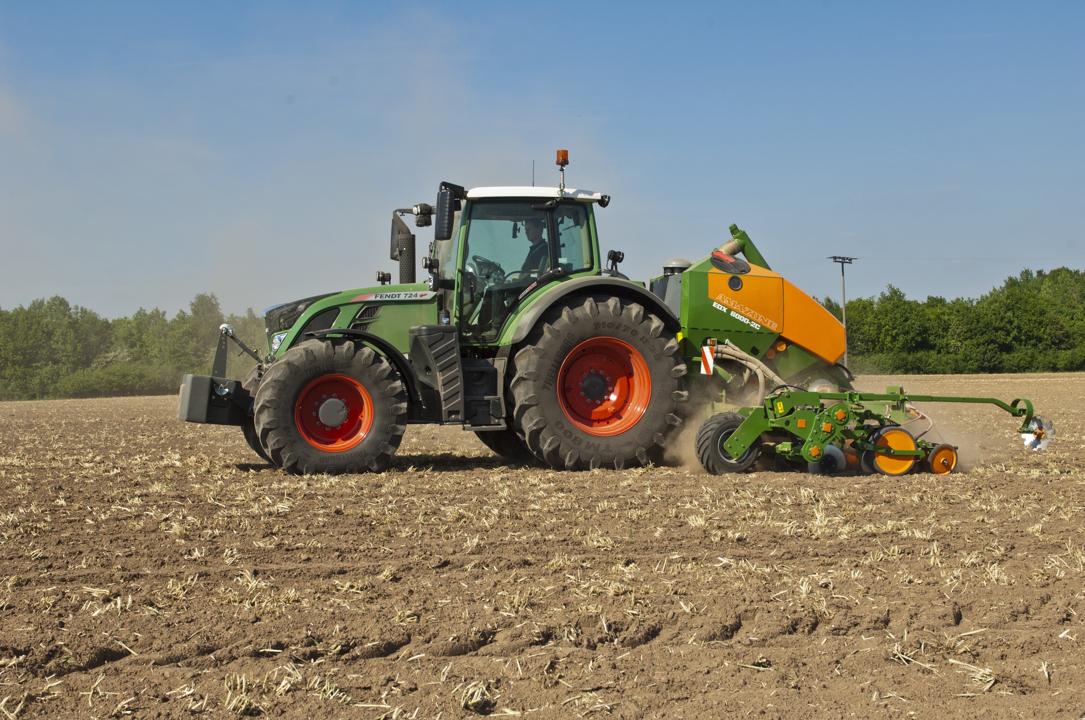 Fendt 724 Vario tractor with seeder in a field HD Wallpaper