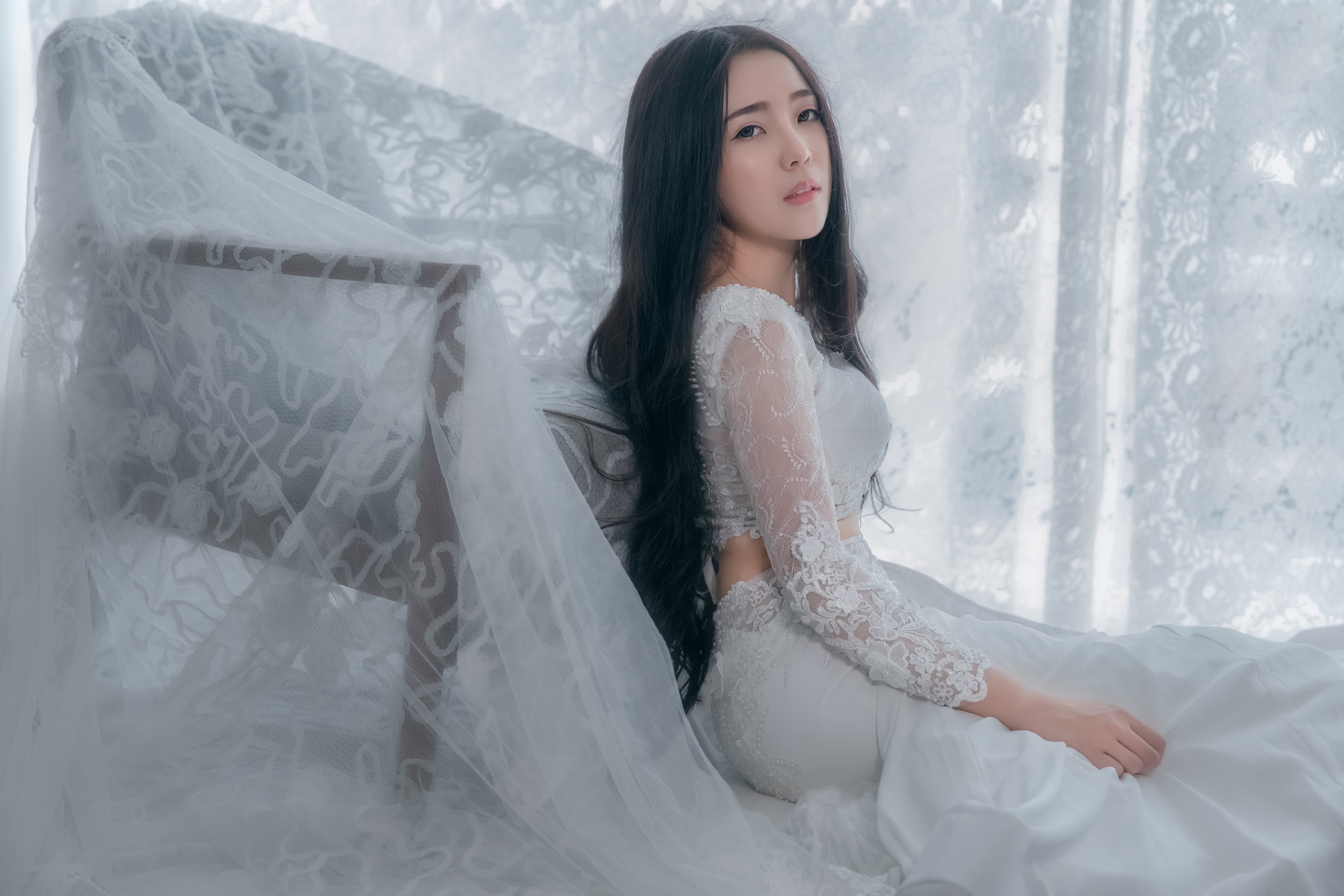 Brunette girl in white dress sitting HD Wallpaper