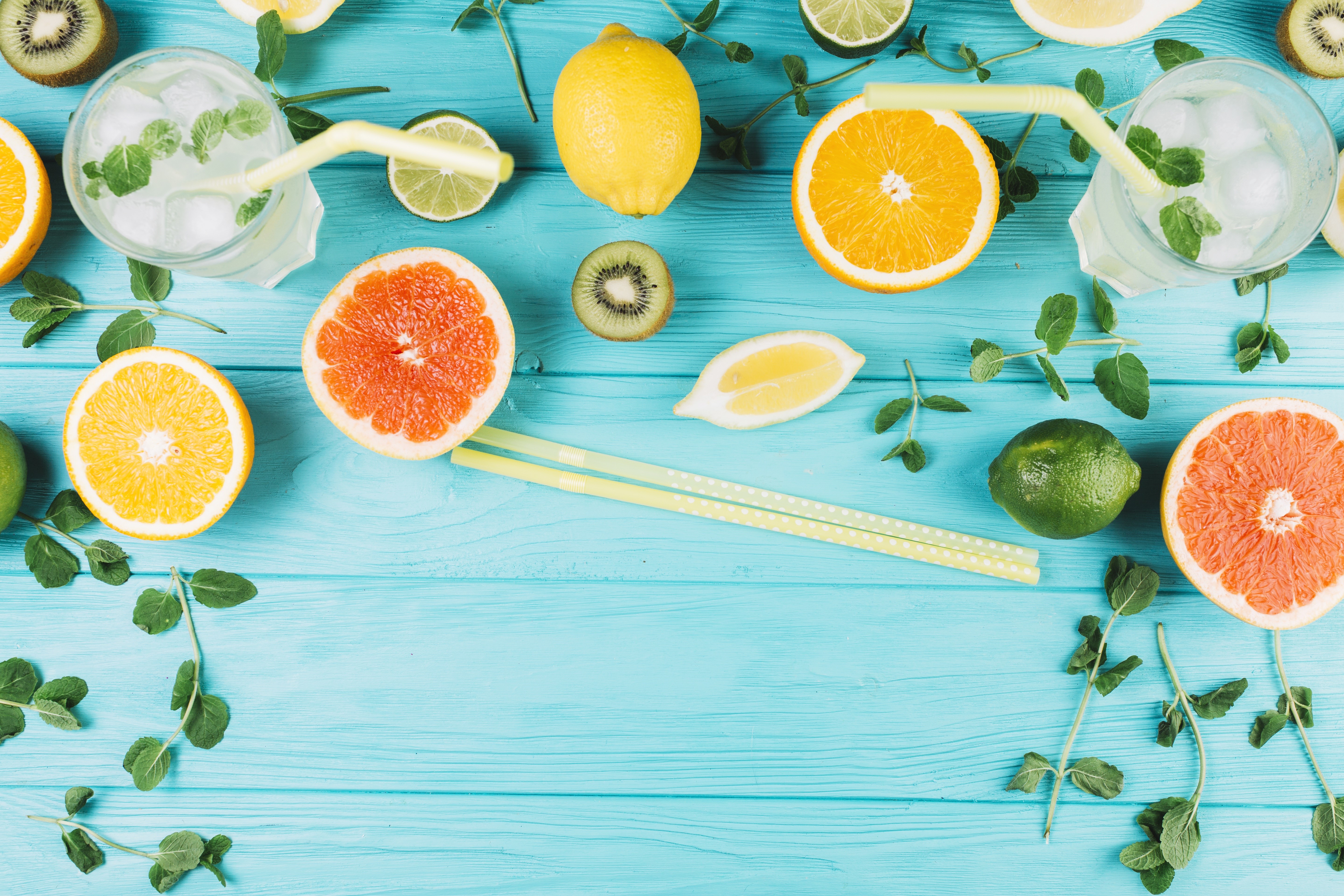 Citrus fruits and drinks on a blue wooden table HD Wallpaper