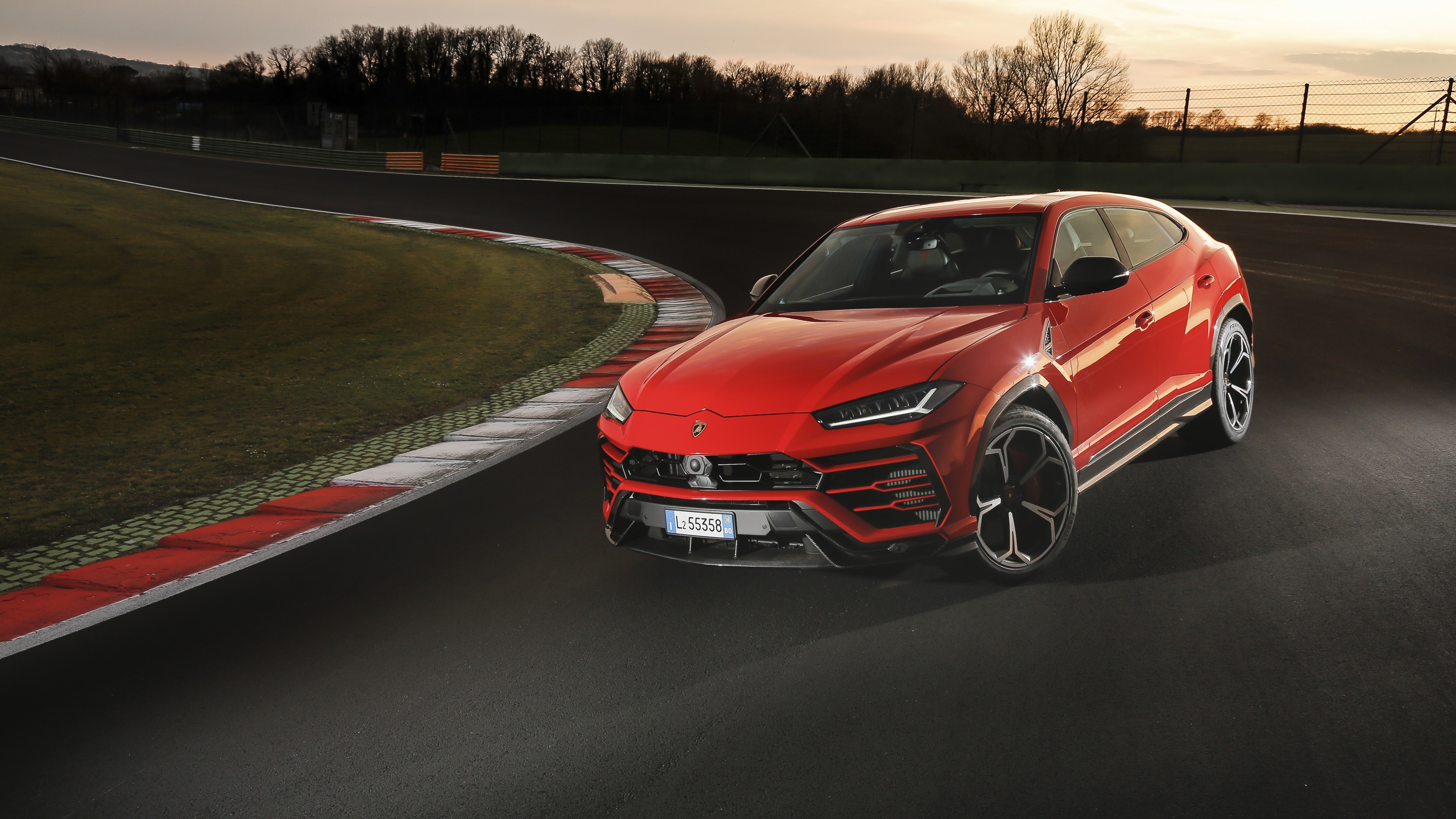 Red Lamborghini Urus on a Race Track HD Wallpaper