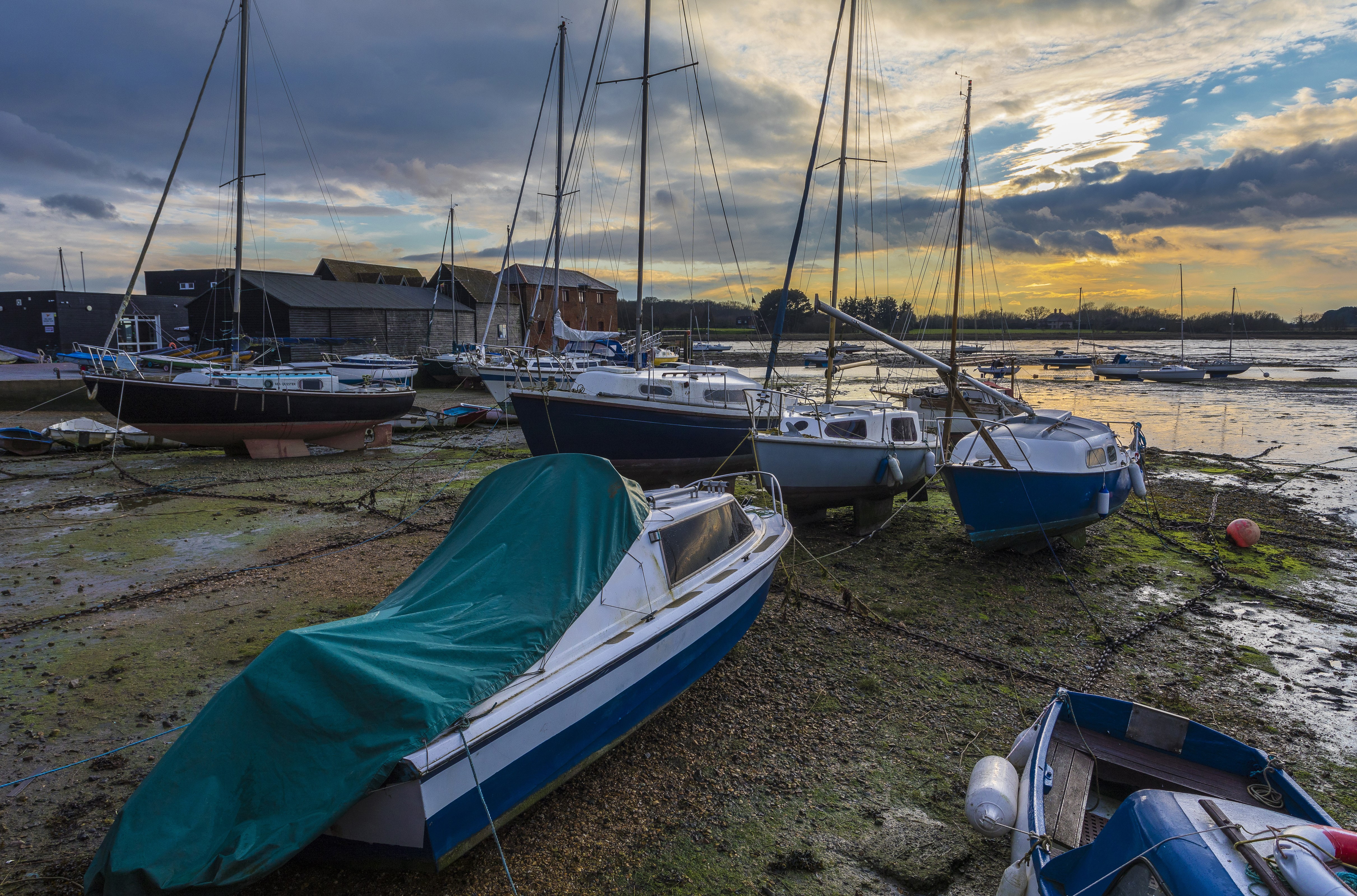 Boats on a Mudflat at Dusk in Fishbourne, England HD Wallpaper