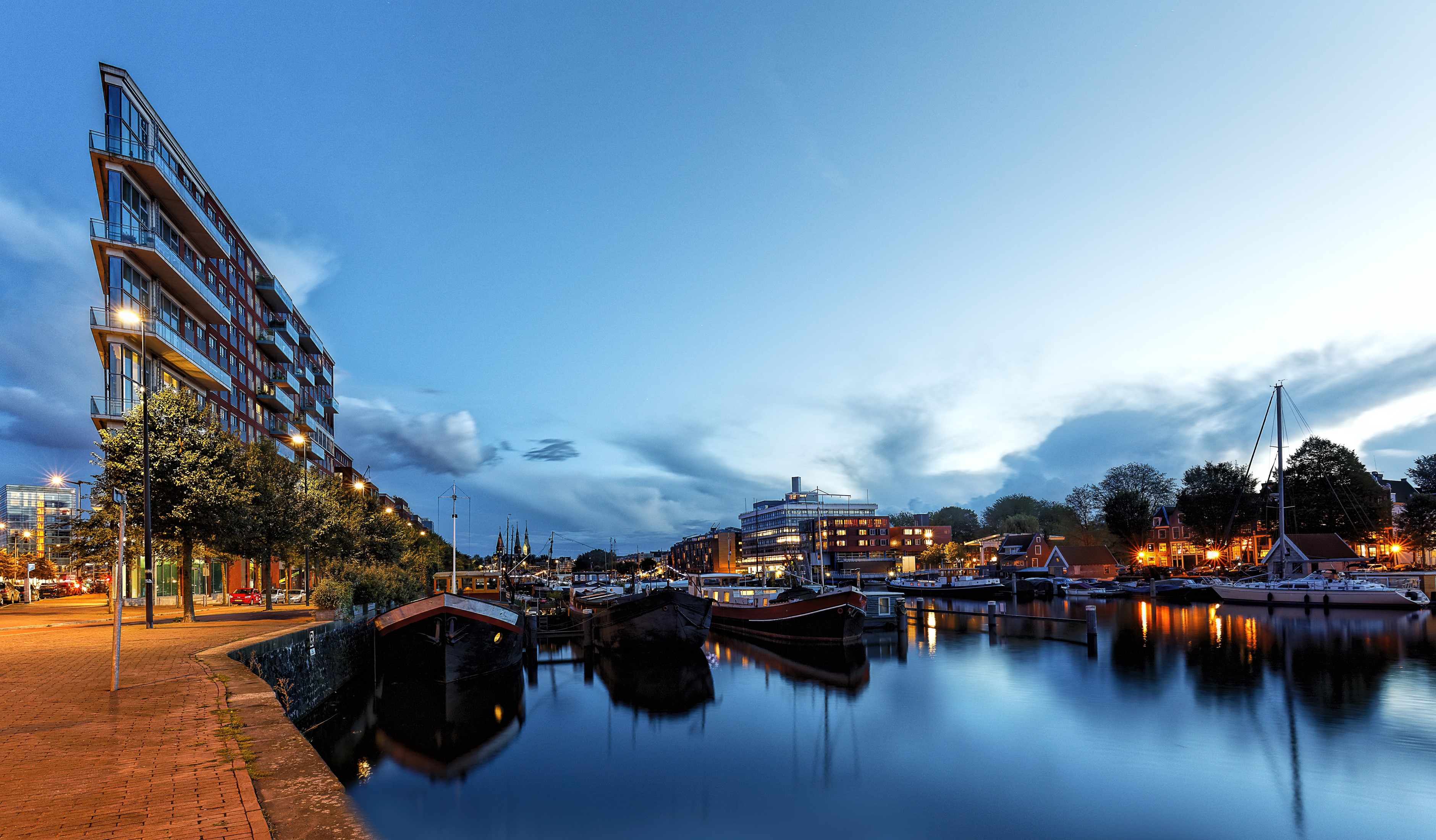 Modern building and boats on canal at dusk HD Wallpaper