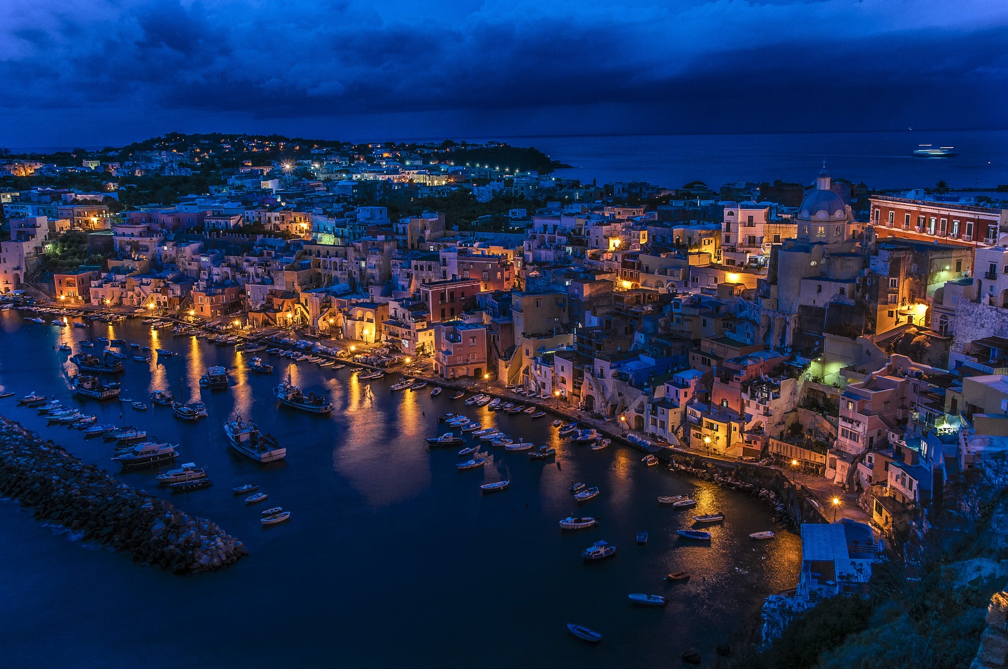 Corricella, Italy at dusk with boats in the bay HD Wallpaper