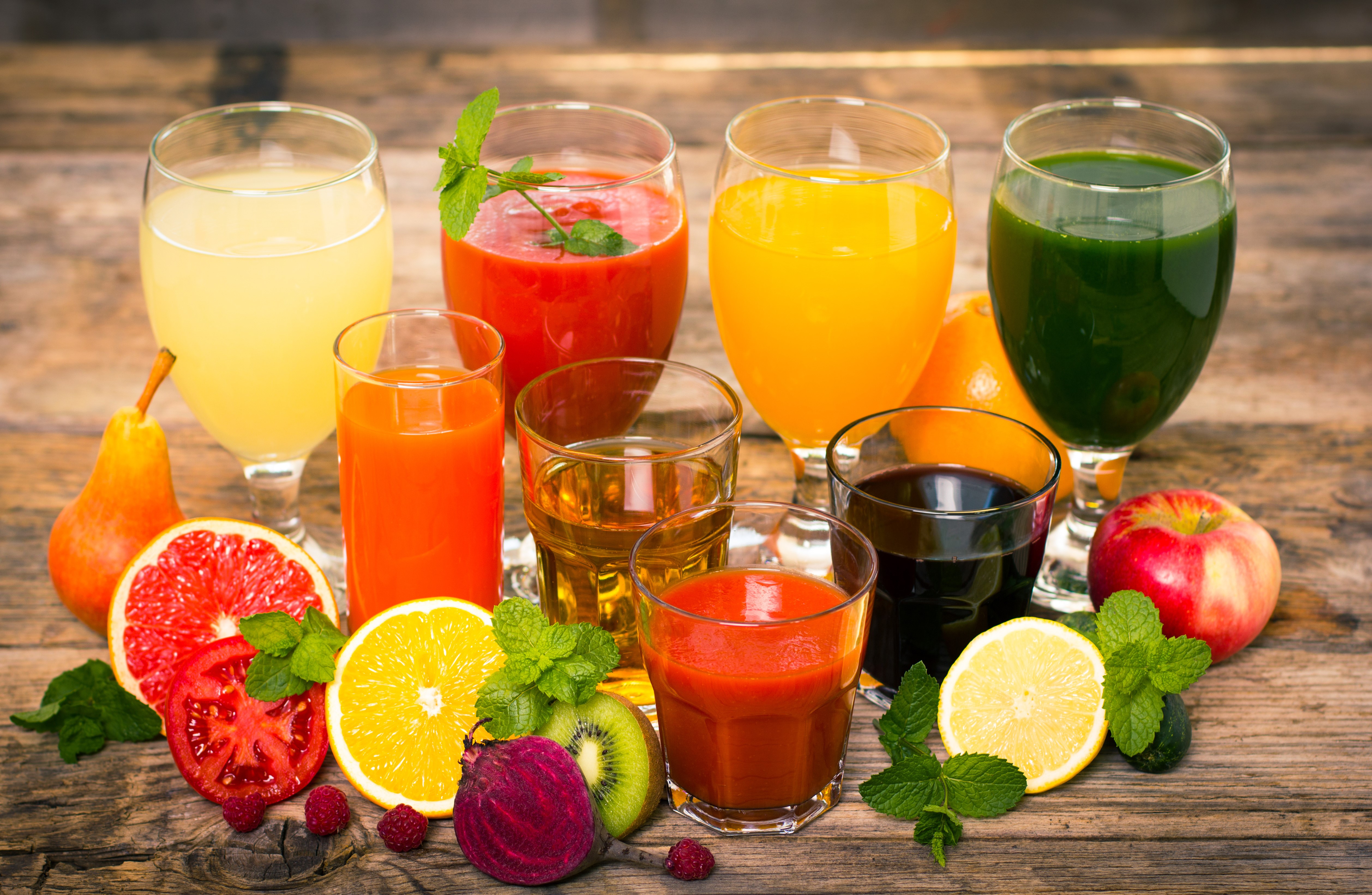 Assortment of Fresh Juices and Fruits on Wooden Table HD Wallpaper