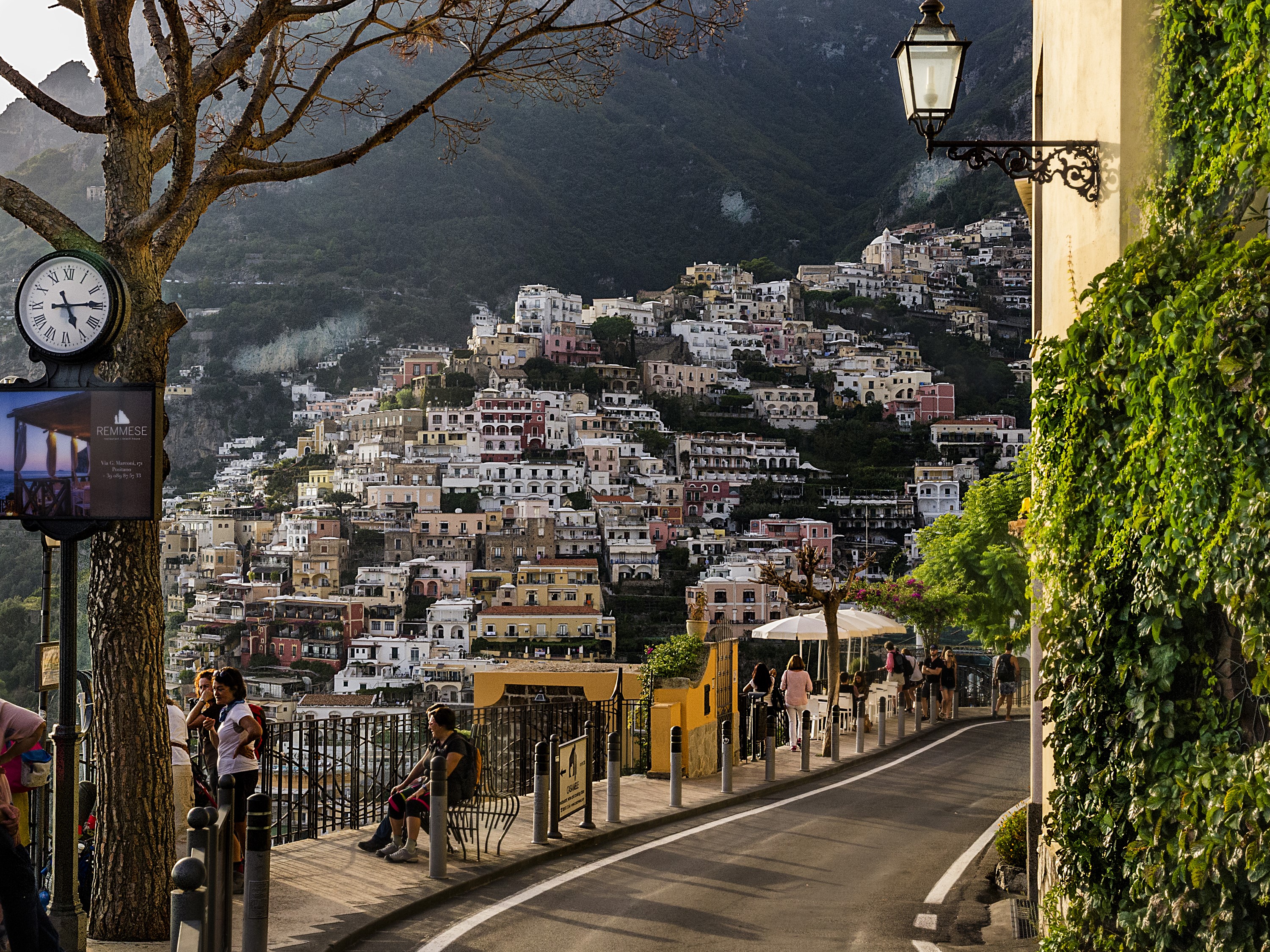 Positano, Italy street with houses on a hill and a clock HD Wallpaper