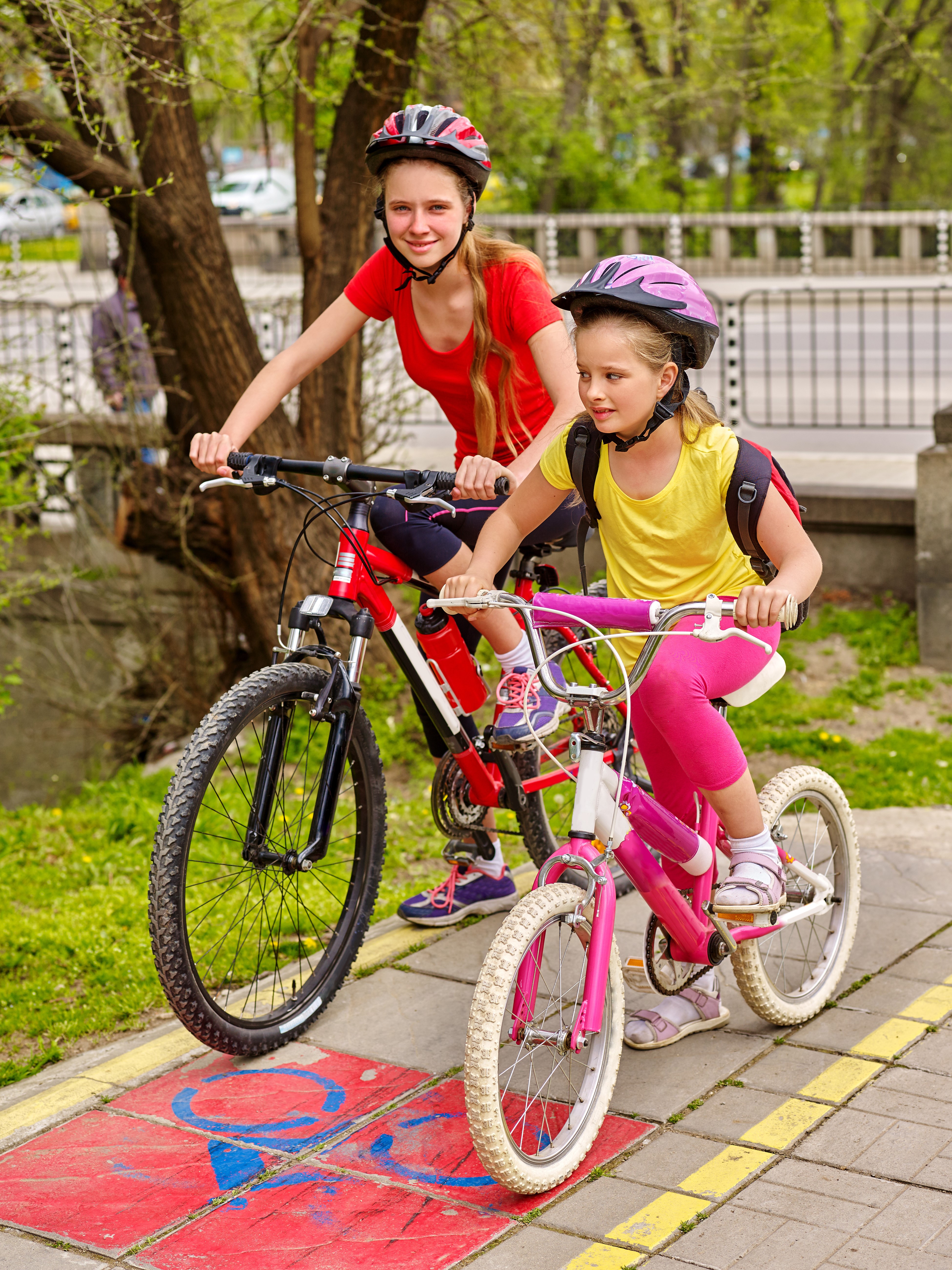 Two girls riding bicycles HD Phone Wallpaper
