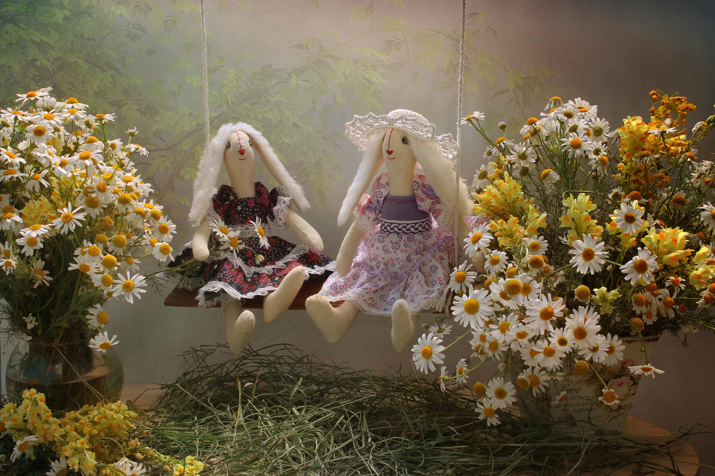 Two bunny dolls on a swing with flowers HD Wallpaper