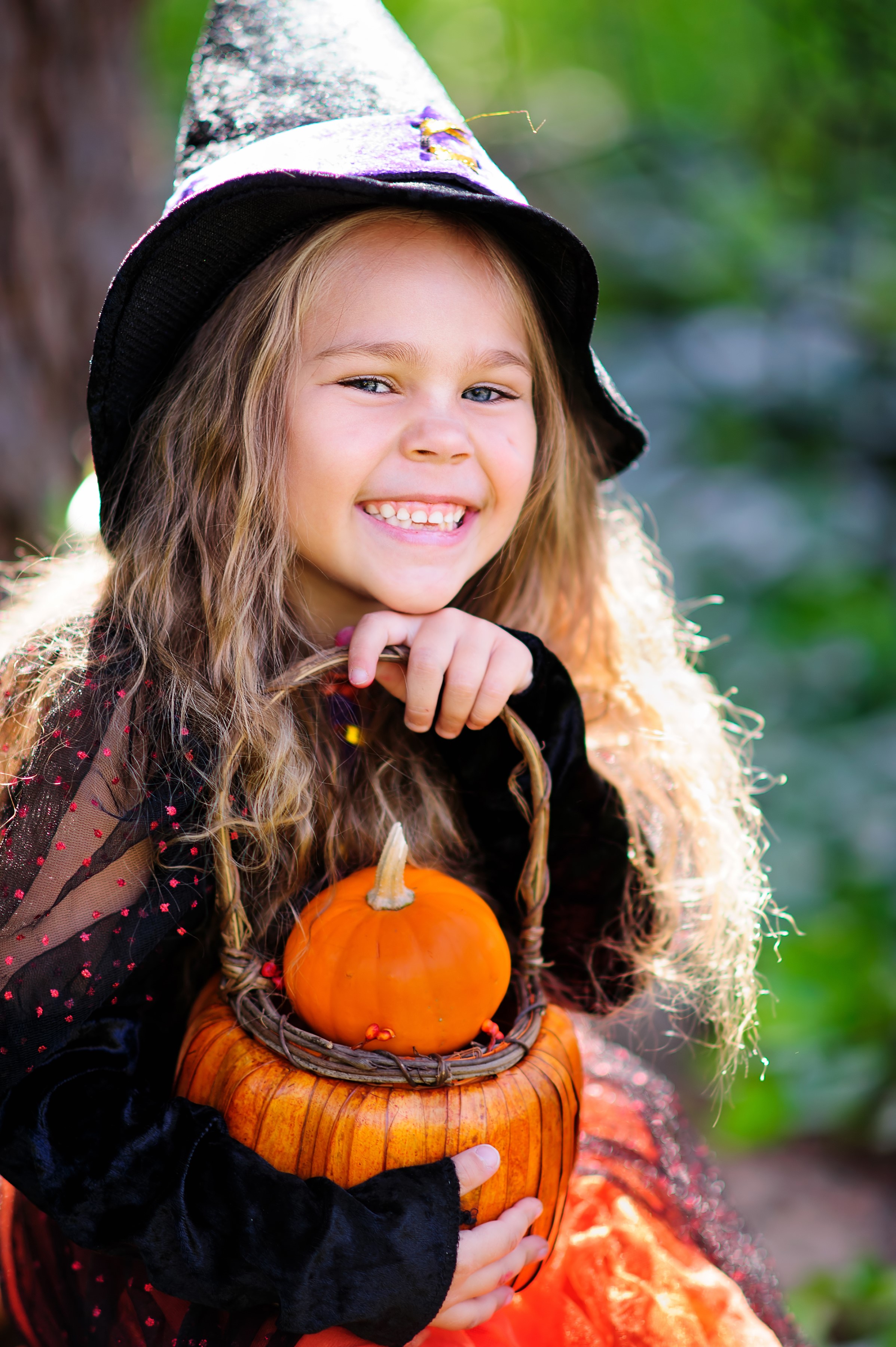 Girl in Witch Costume Holding Pumpkin Basket HD Phone Wallpaper