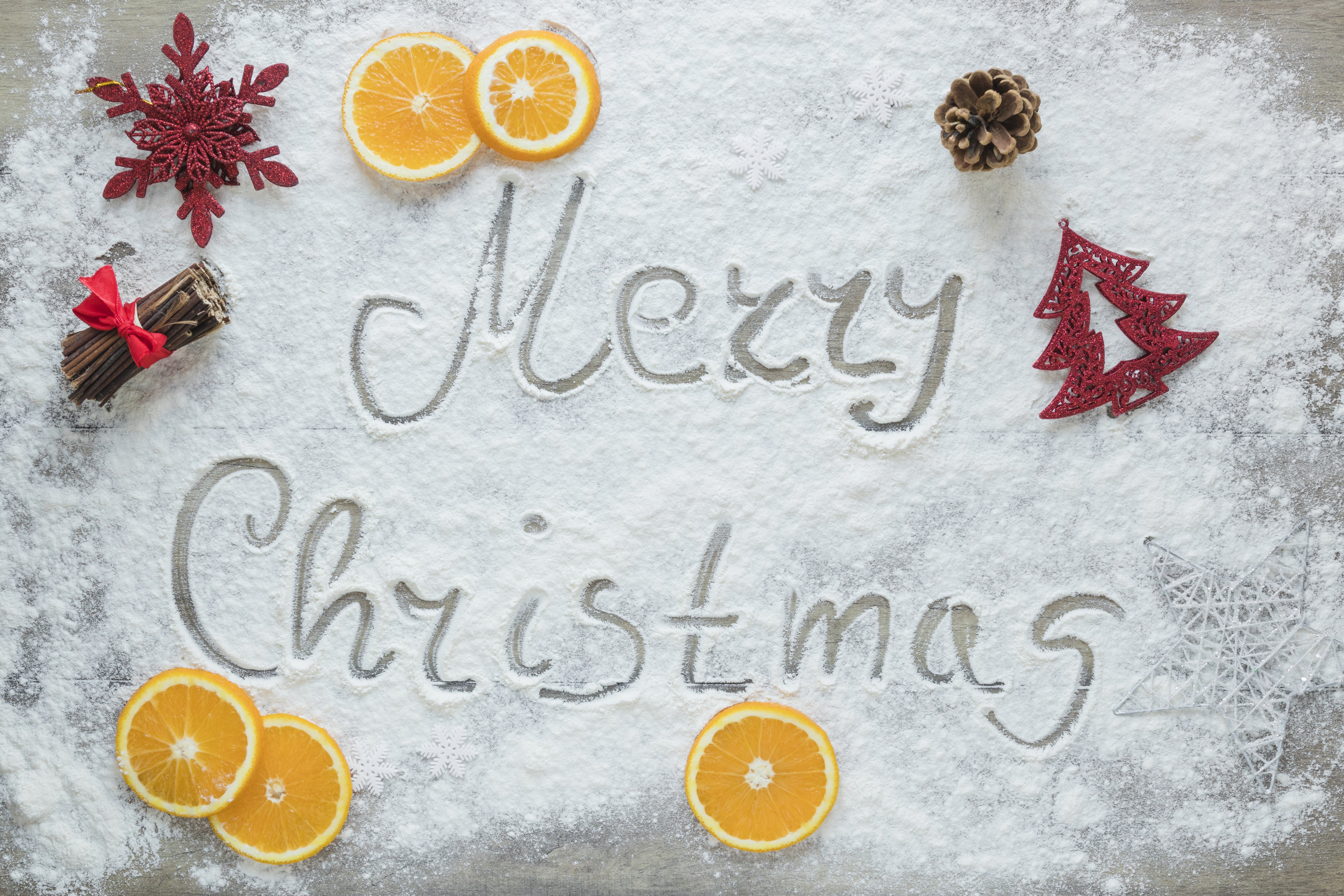 Merry Christmas written in powdered sugar with decorations HD Wallpaper