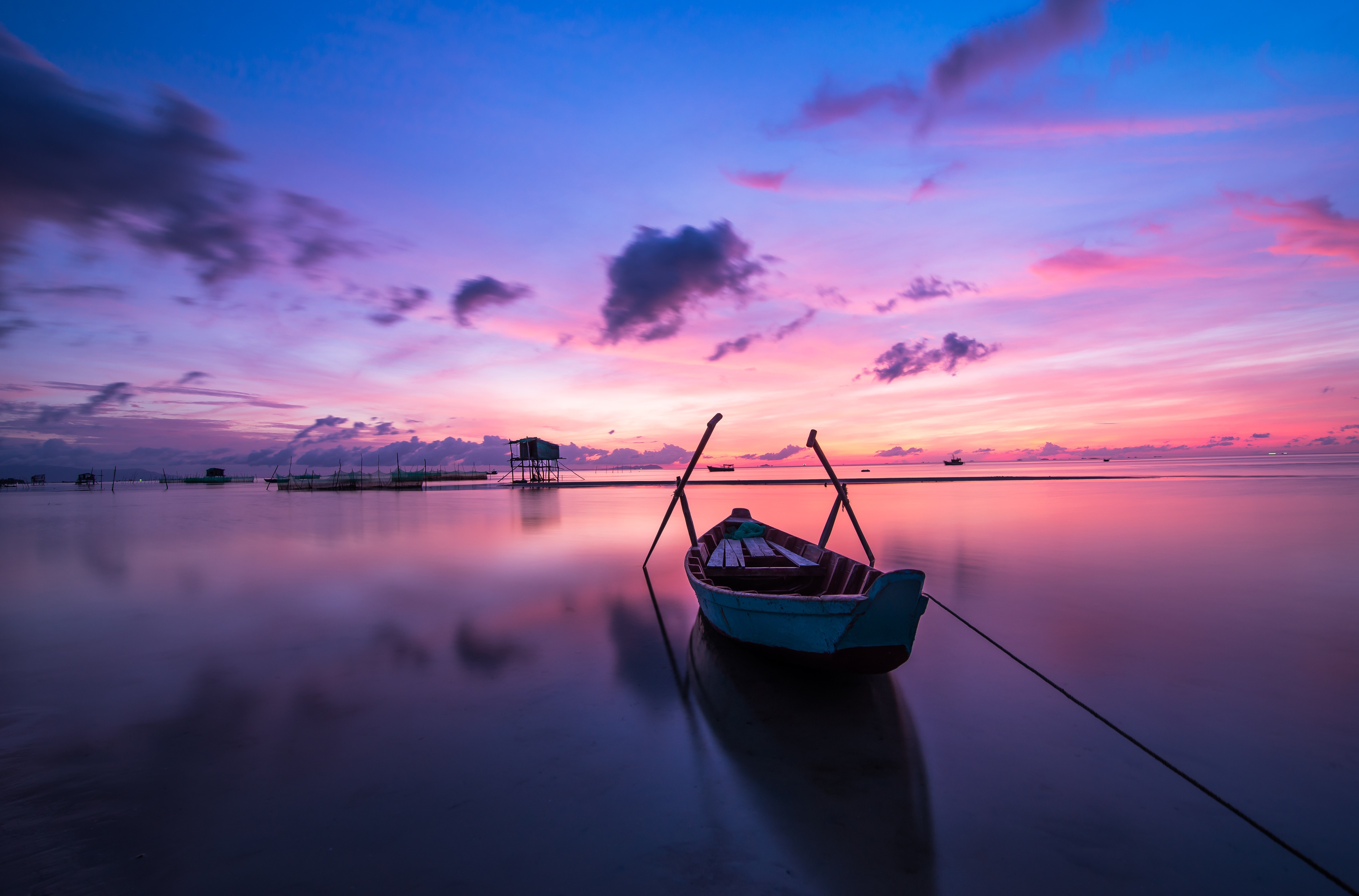 Boat on calm water during sunrise with colorful sky HD Wallpaper