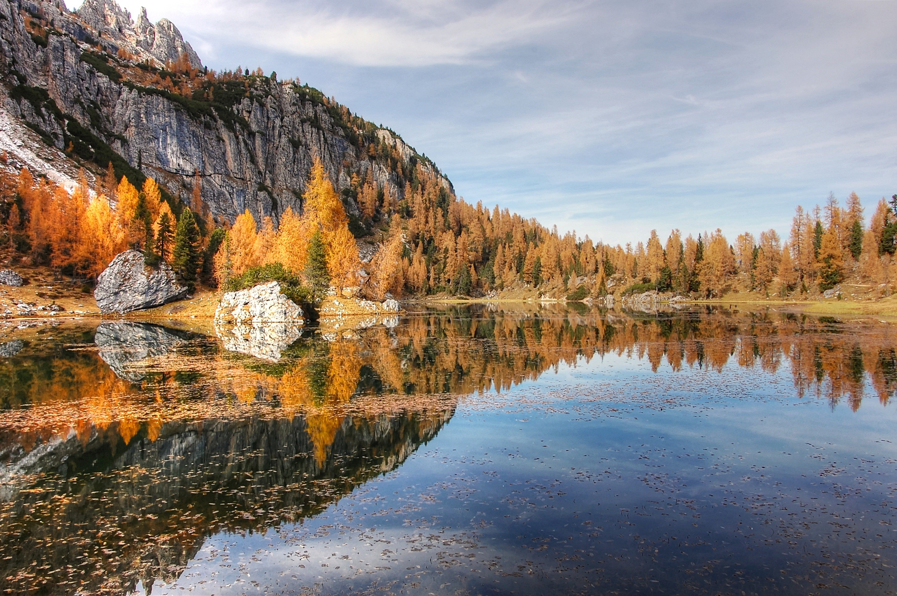 Autumn lake reflecting mountains and golden trees HD Wallpaper