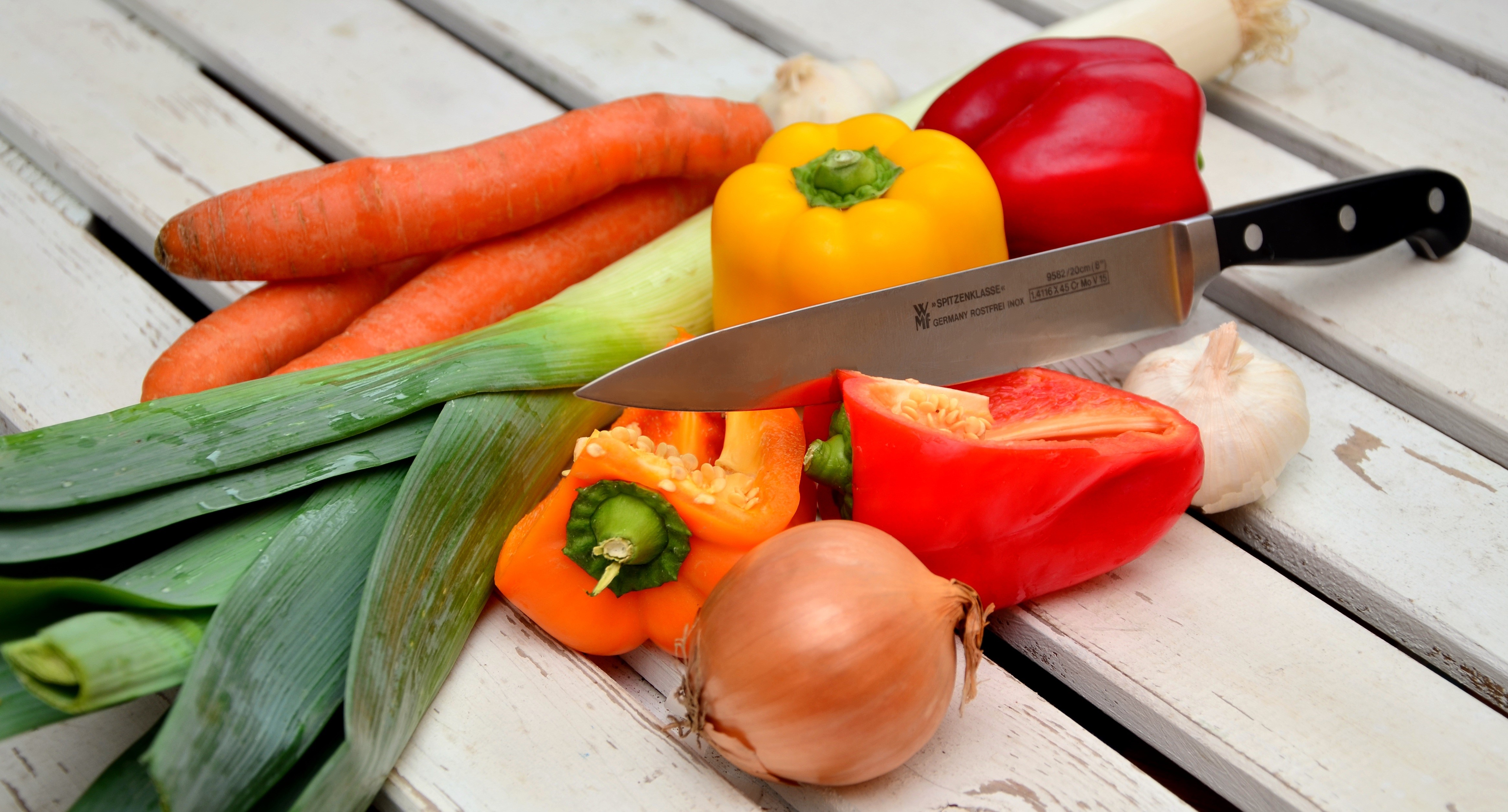 Vegetables and a knife on wood planks HD Wallpaper