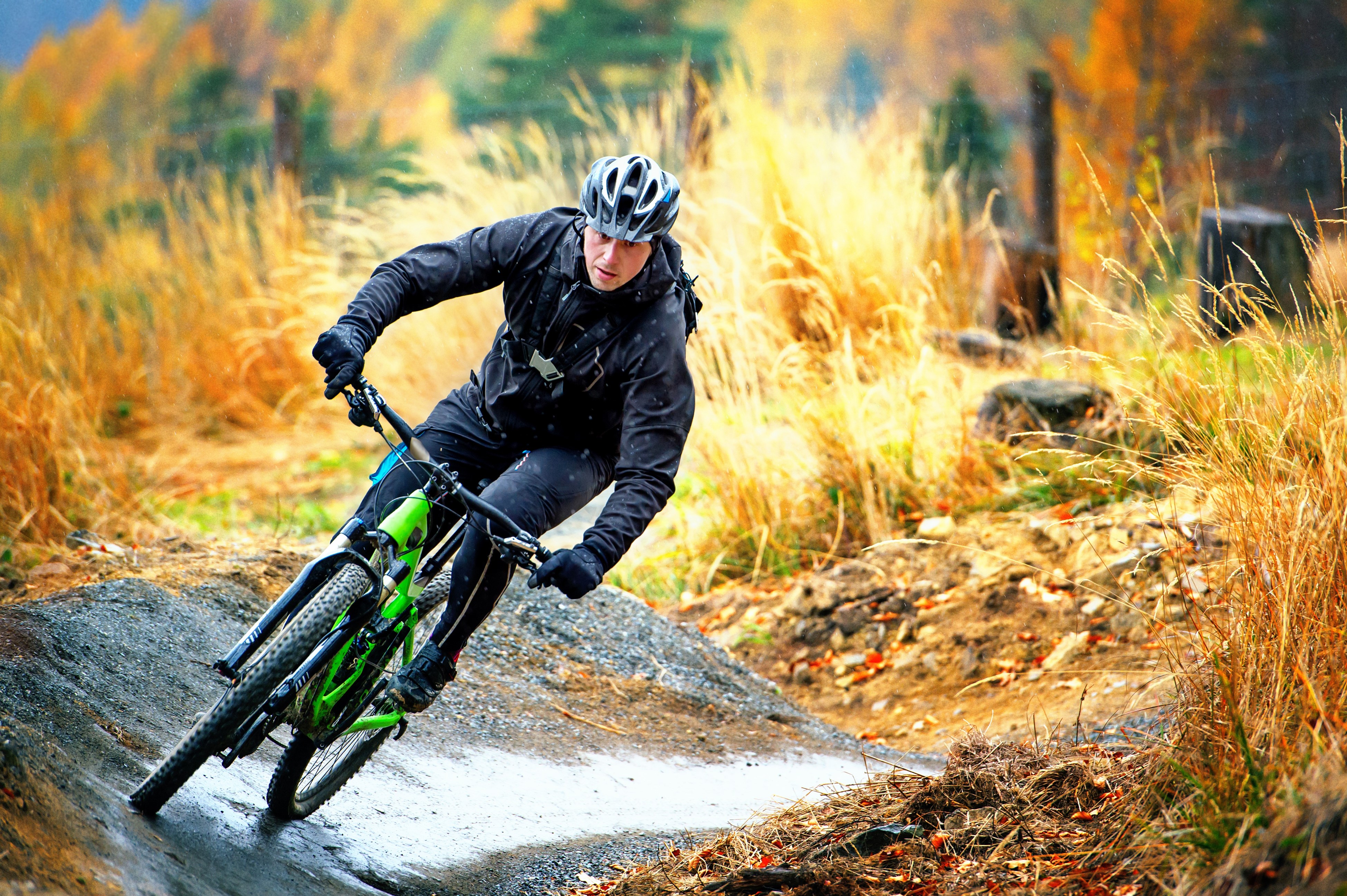 Man riding a bicycle on a trail HD Wallpaper