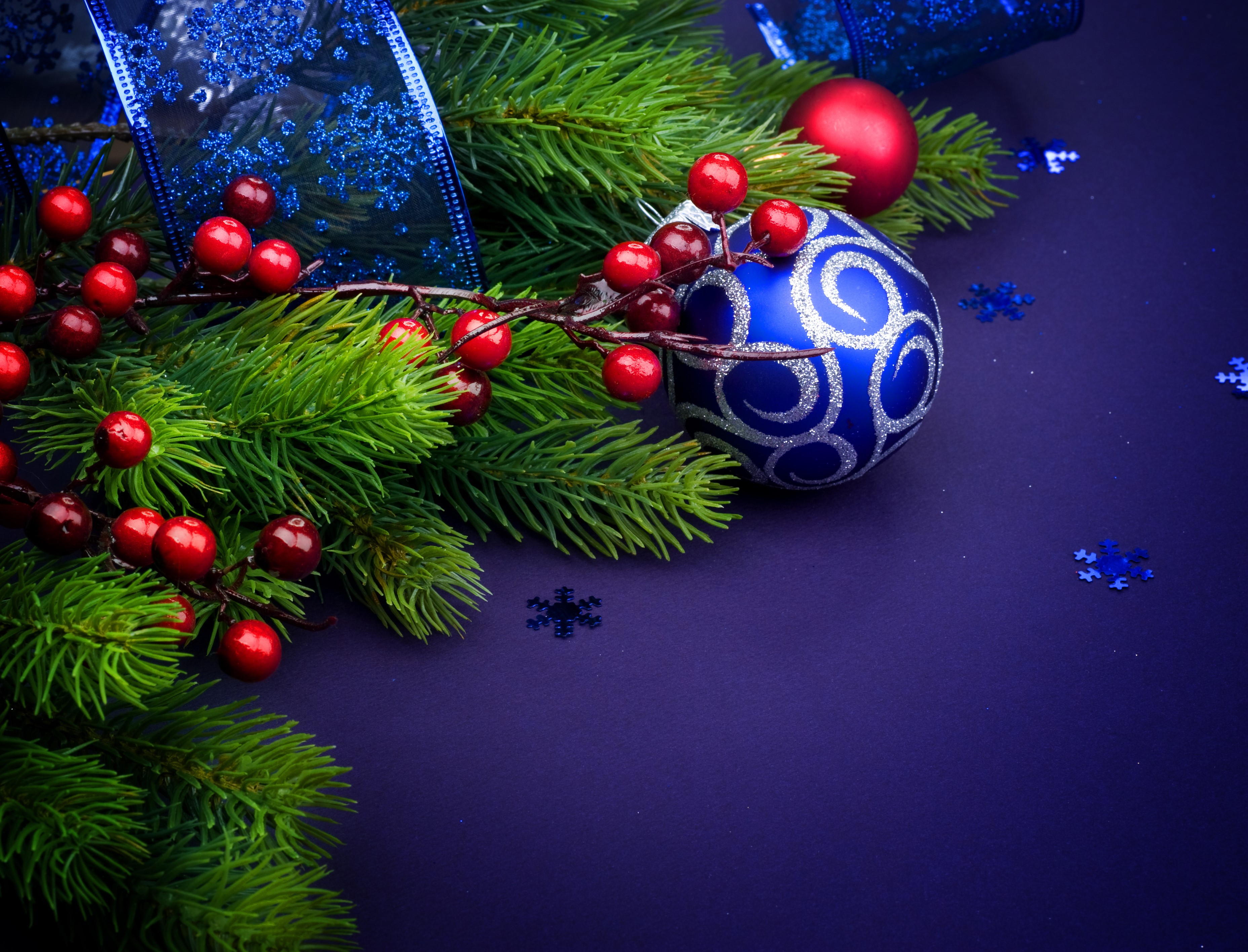 Christmas fir branches with red berries and blue ornaments HD Wallpaper