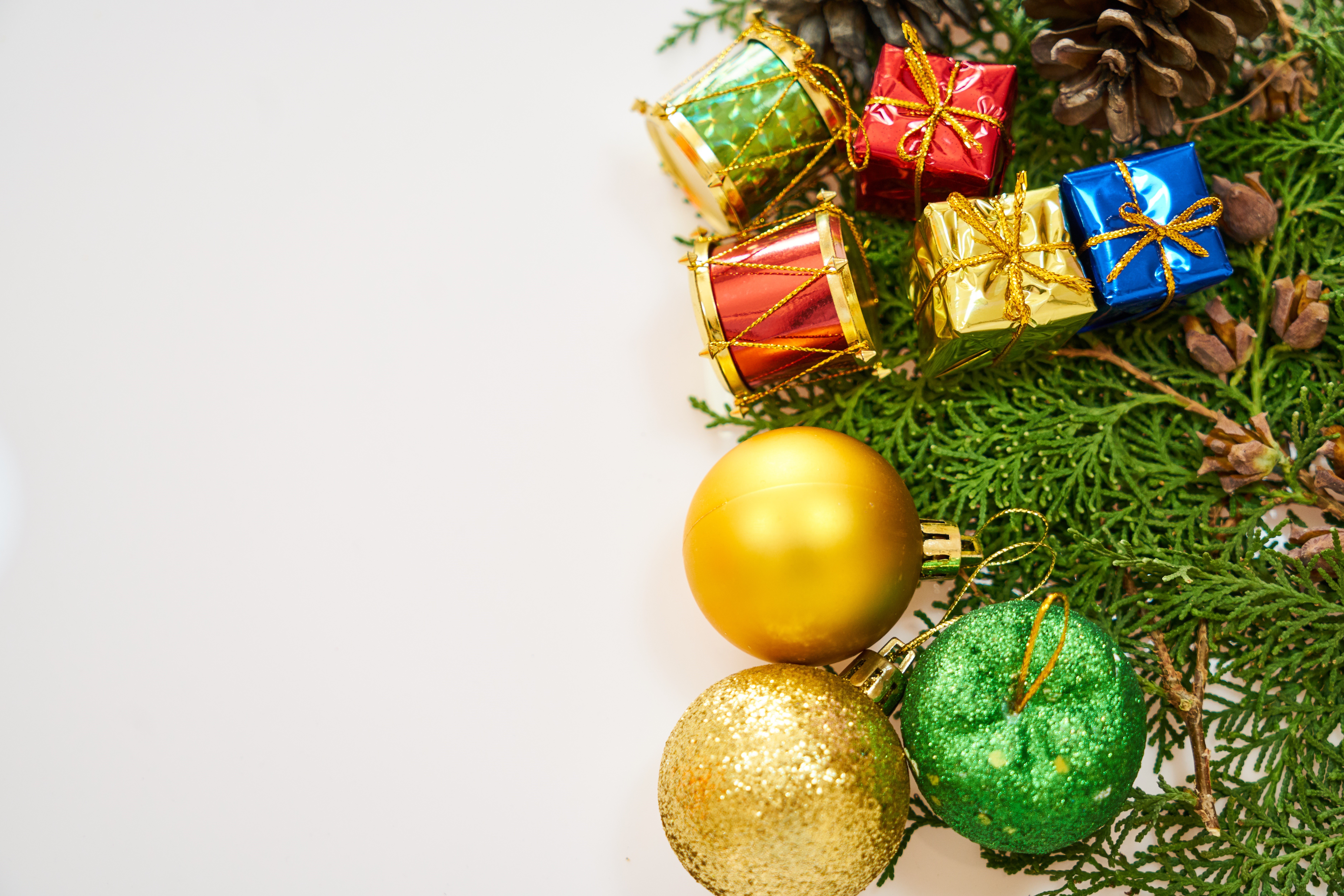 Christmas ornaments and pine cones on a white background HD Wallpaper