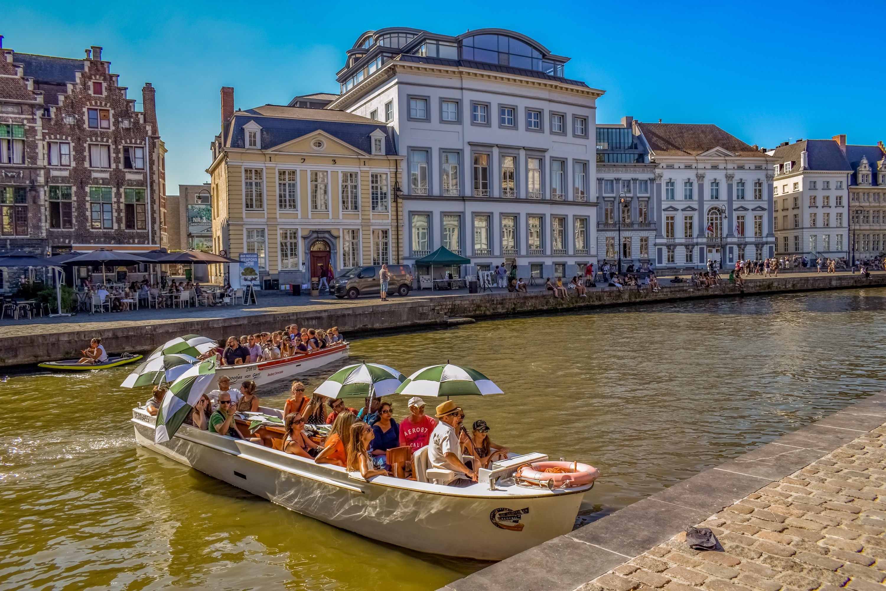 Boats on a canal in Ghent, Belgium with historic houses HD Wallpaper