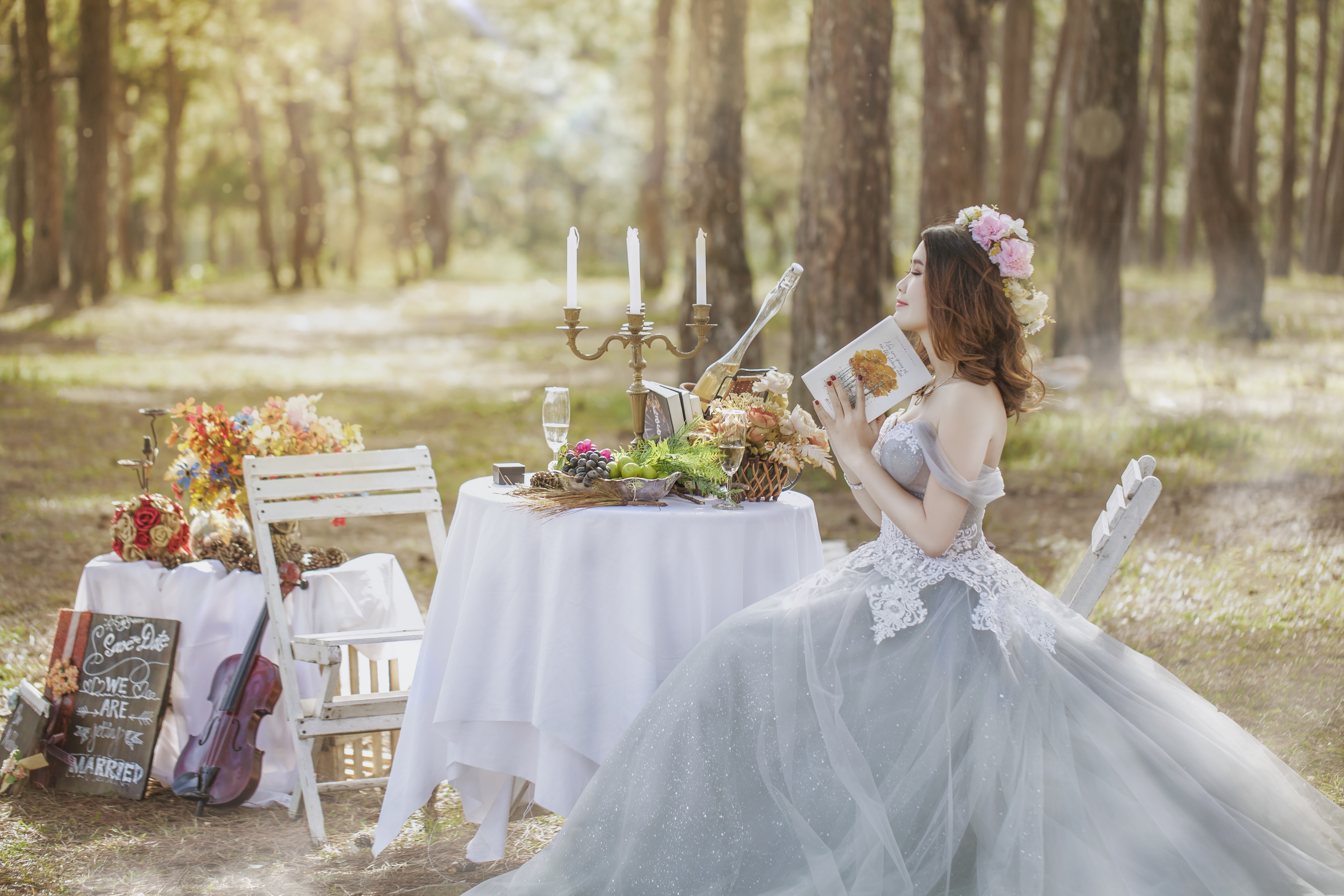 Bride in a wedding dress reading a book at a table HD Wallpaper
