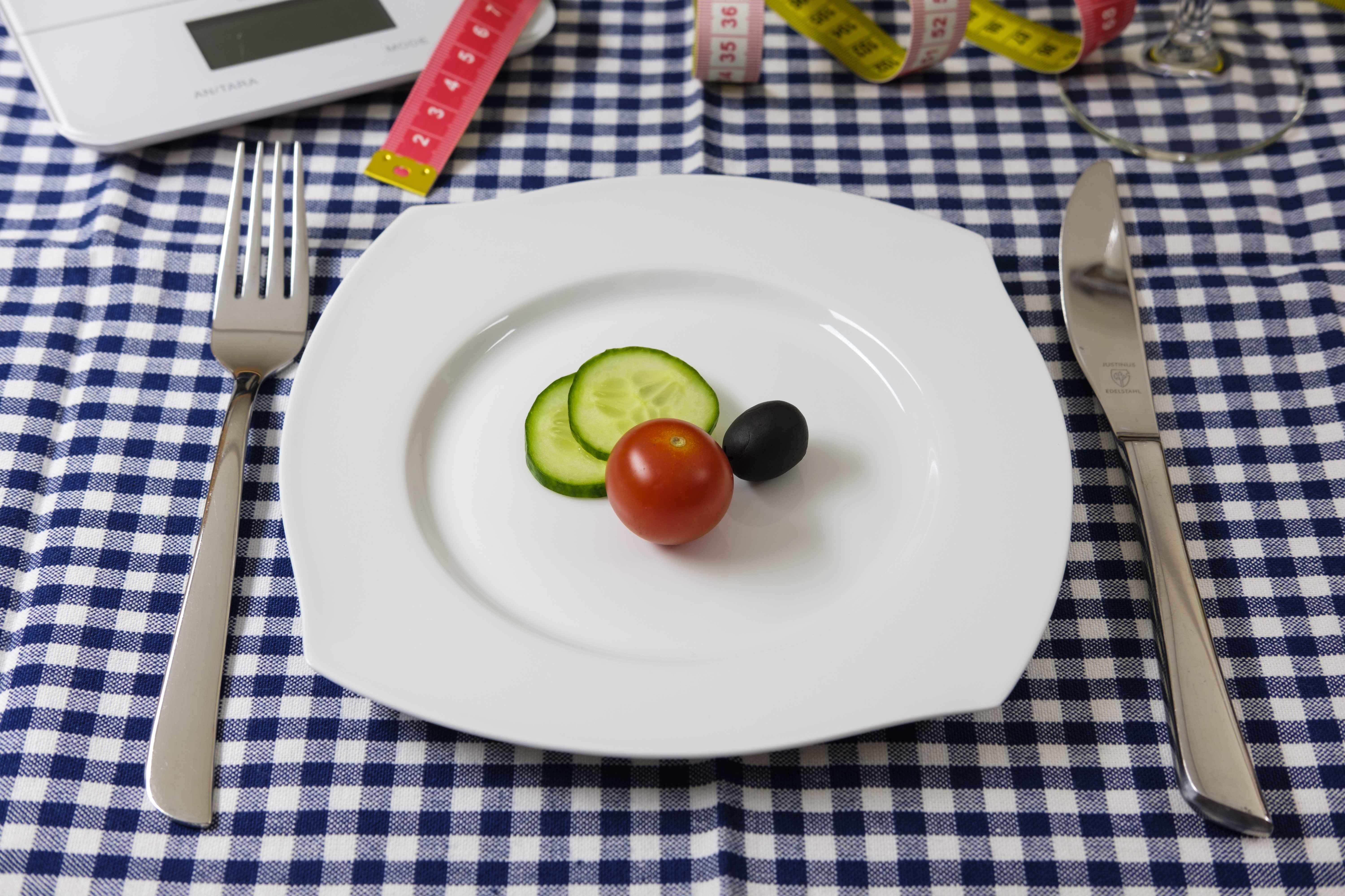 Plate with tomato, cucumber, olive, fork, knife, and measuring tape HD Wallpaper