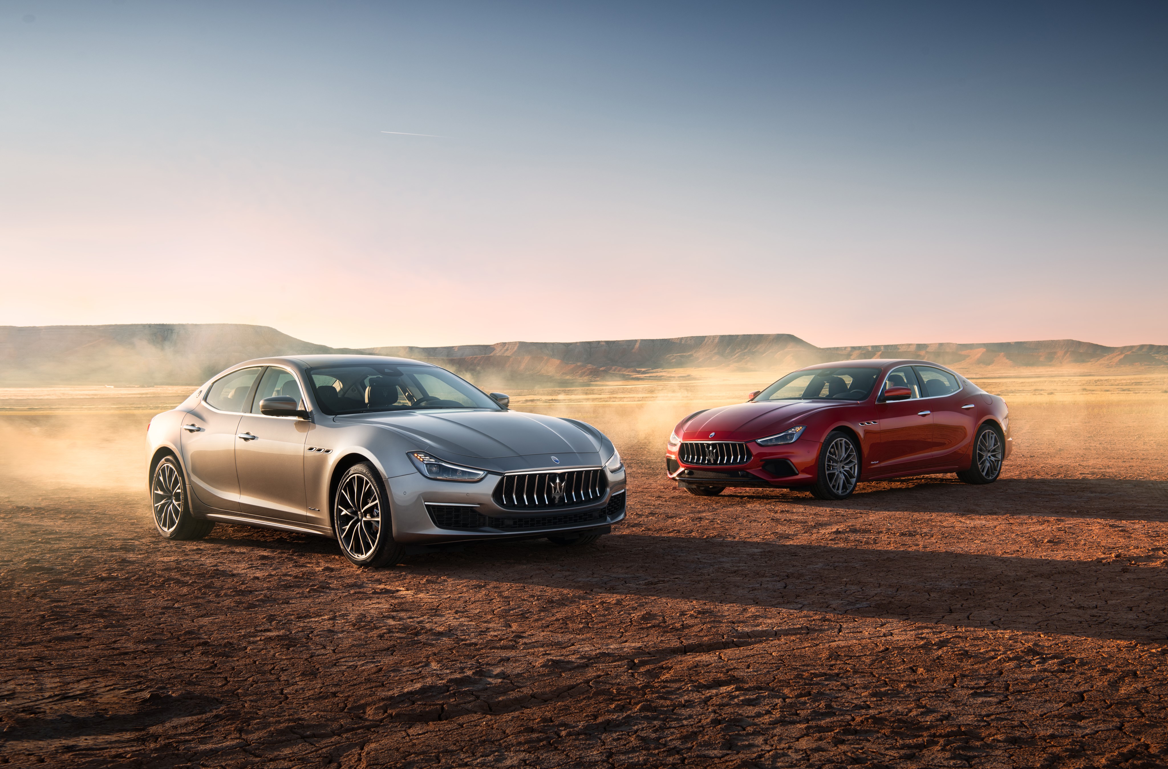 Two Maserati Ghibli cars in desert landscape HD Wallpaper
